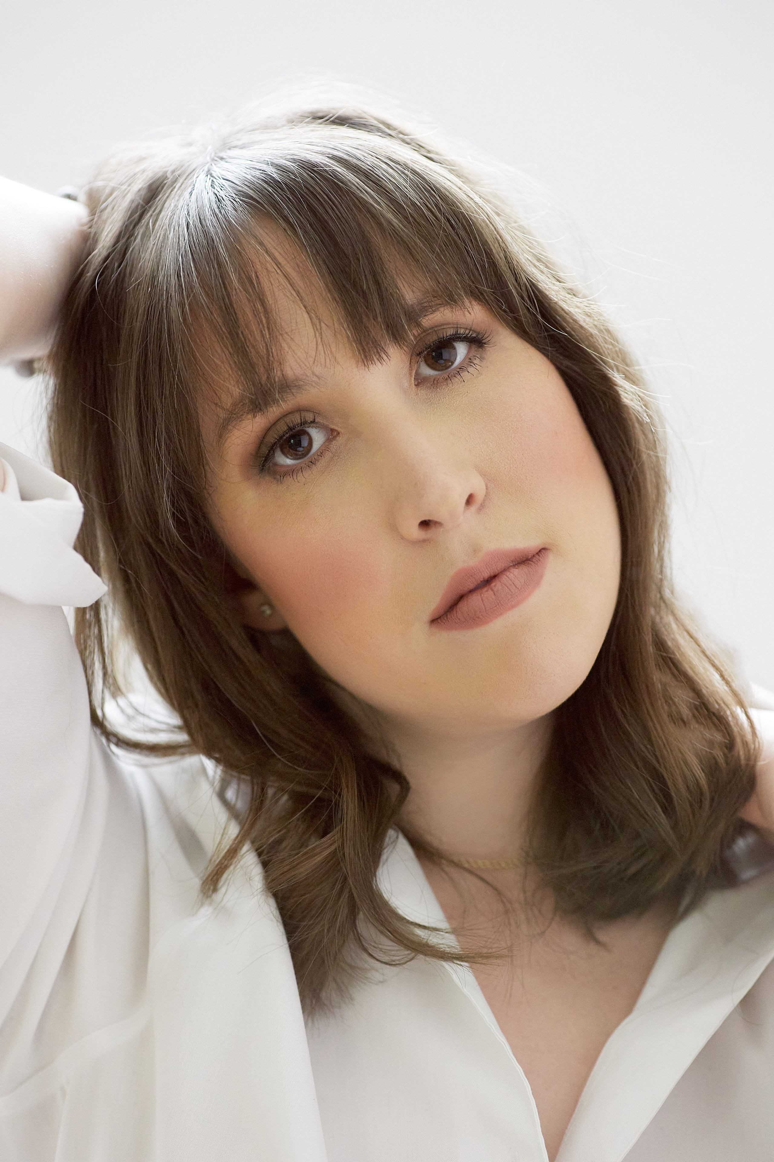 headshot of model with long brown hair and brown eyes 