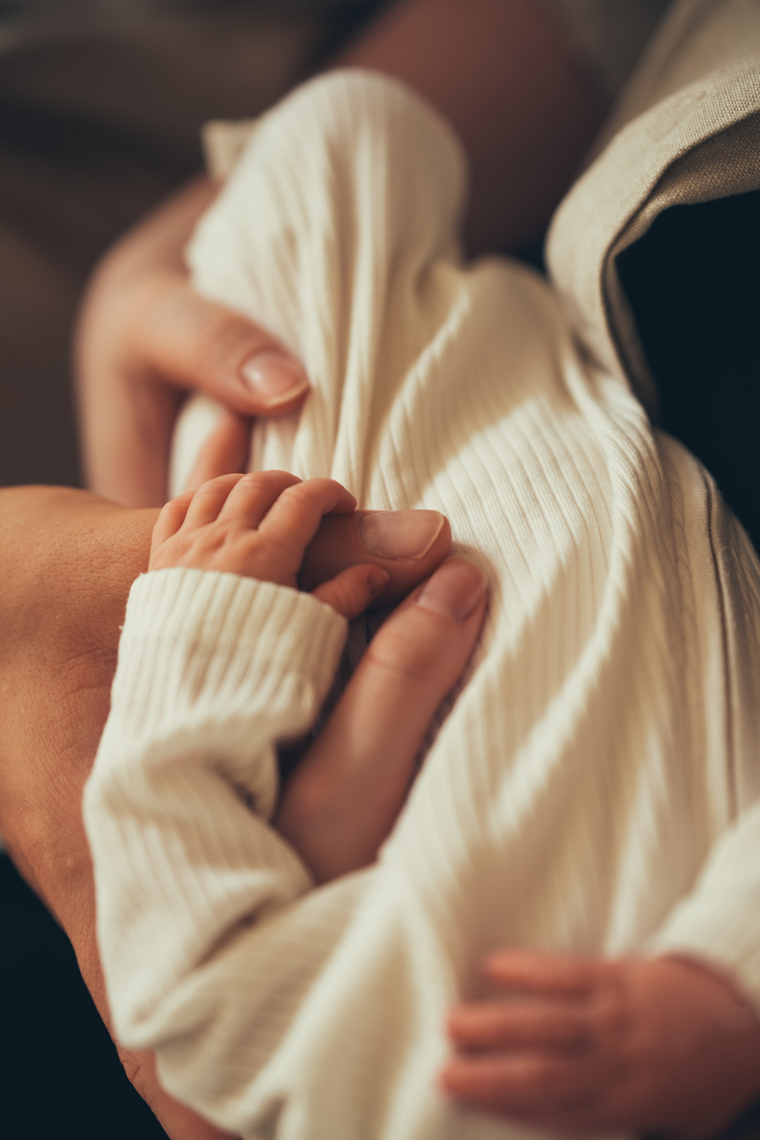 Lifestyle newborn photography at home showing parents bonding with their baby in Birmingham