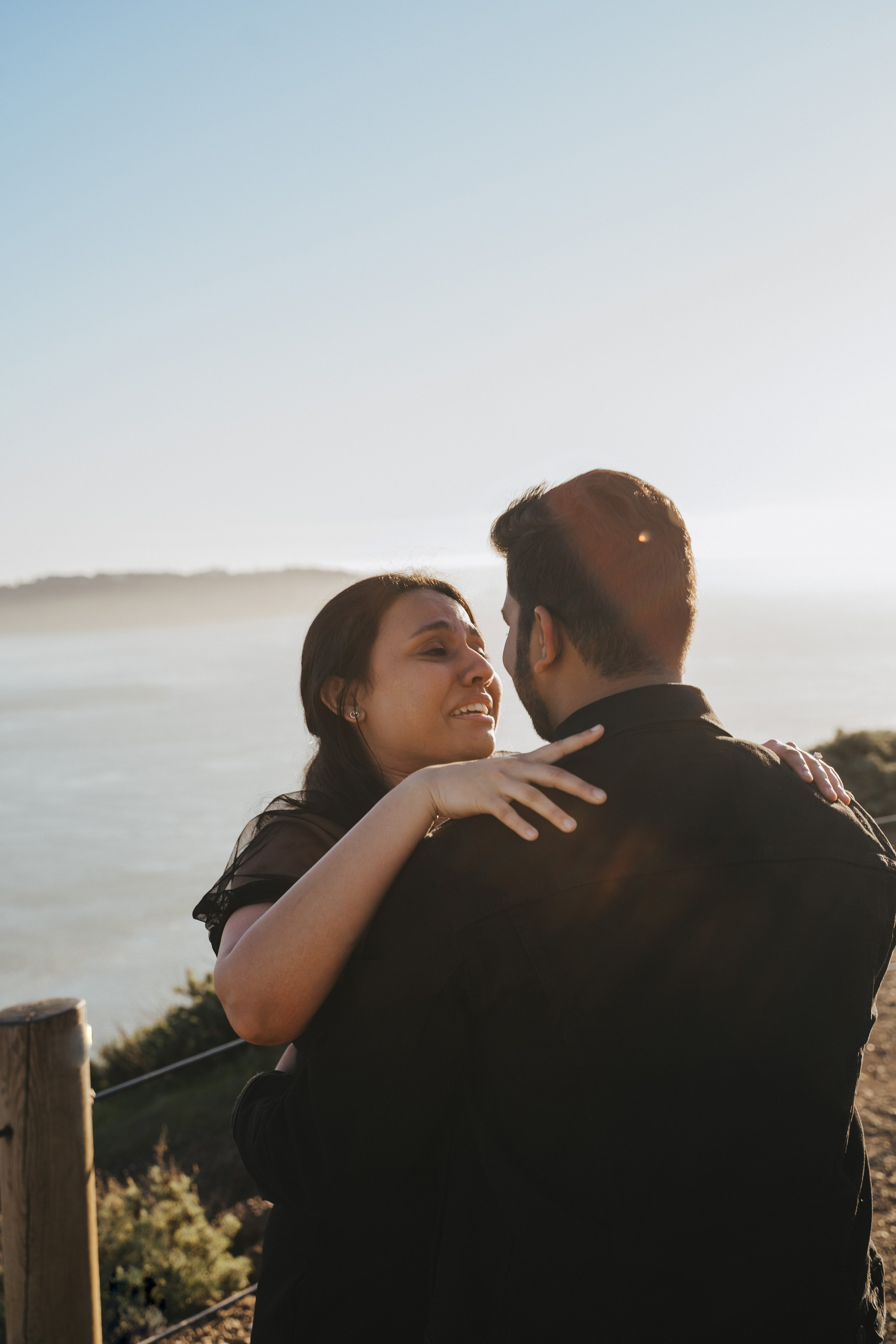 Proposal.  Overlooking the golden San Franisco Bridge sunset with a couple. Photographer Video. 