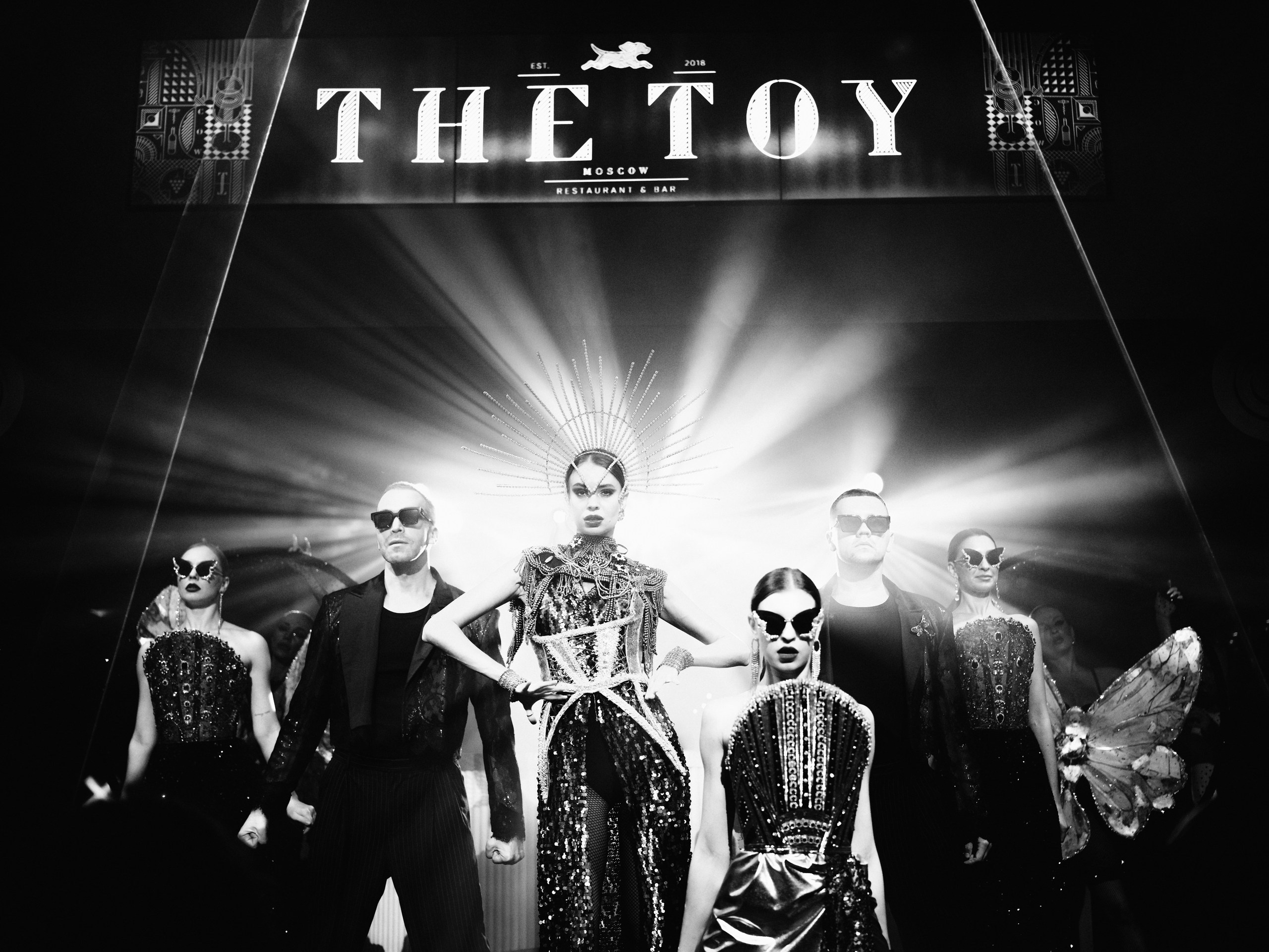 A performer's dramatic entrance on stage at a high-production value club show.