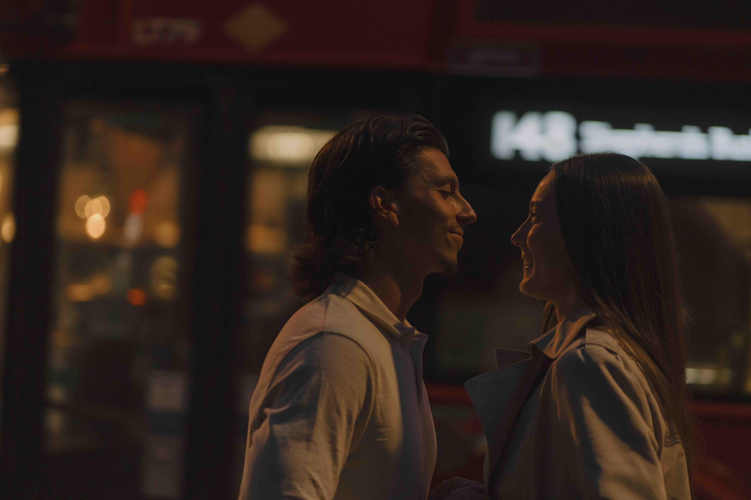 Couple silhouette kissing at sunset London engagement golden hour