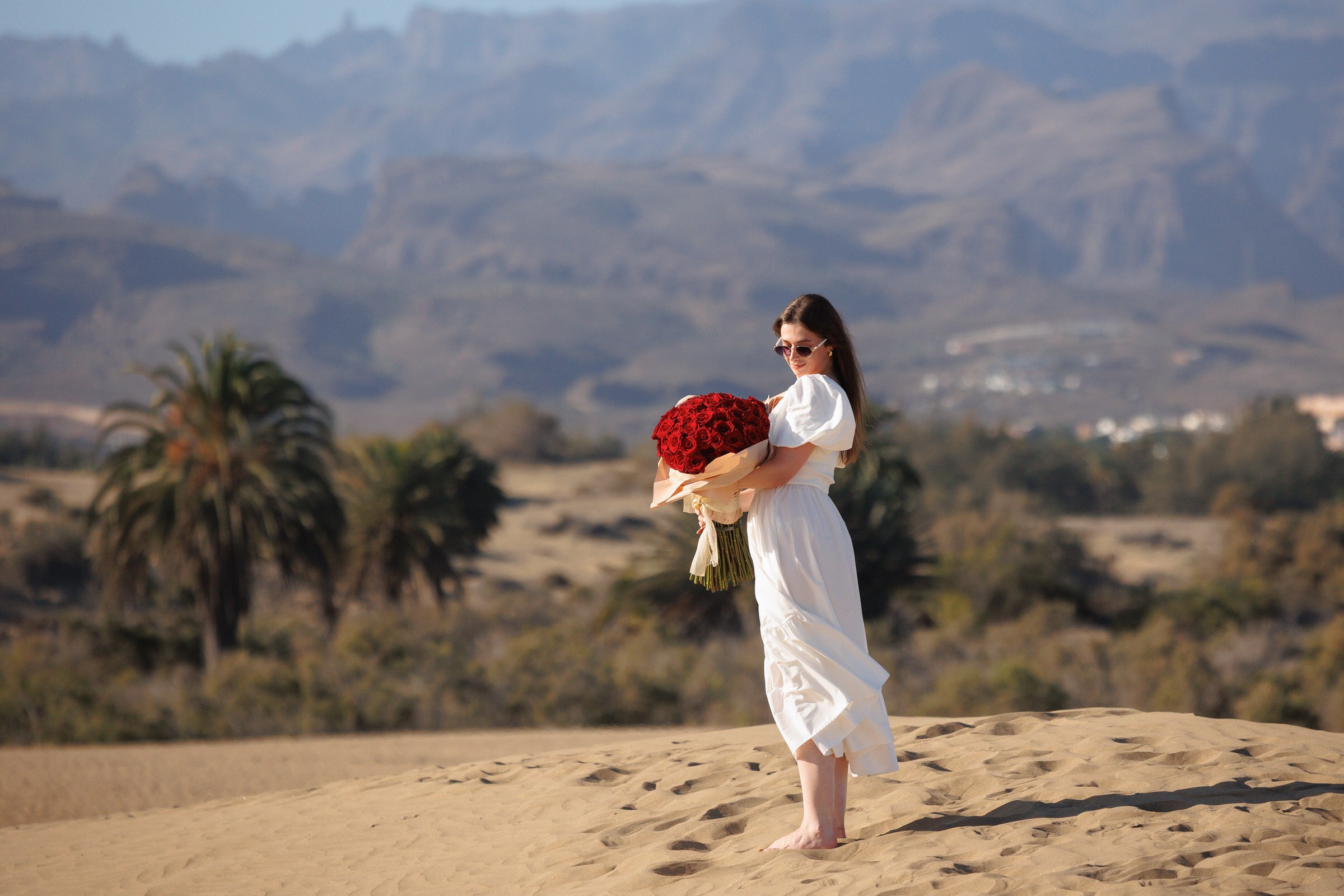 Woman holding a bouquet of 81 roses after a marriage proposal, Gran Canaria