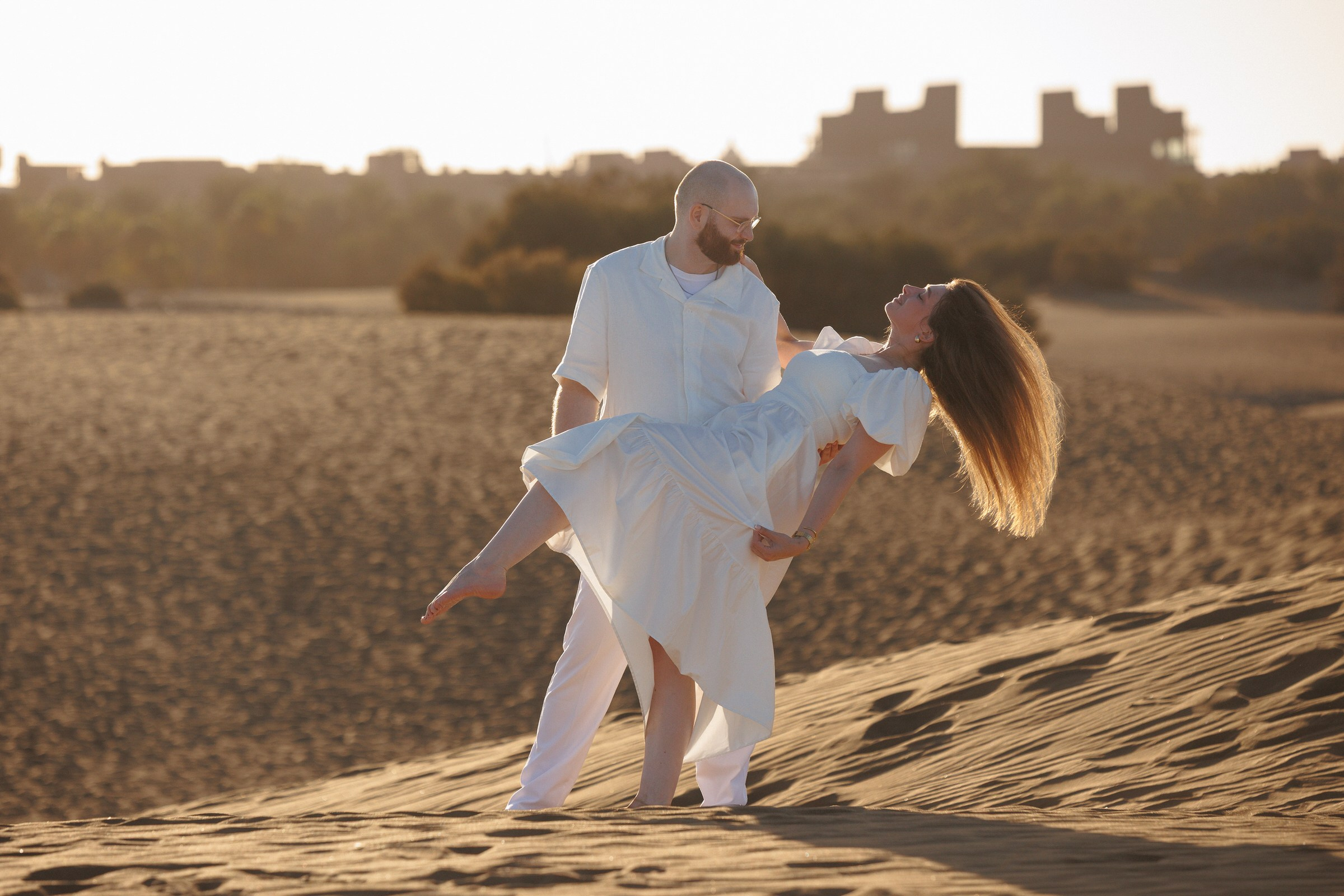 Couple playing on Maspalomas dunes at sunset, Gran Canaria