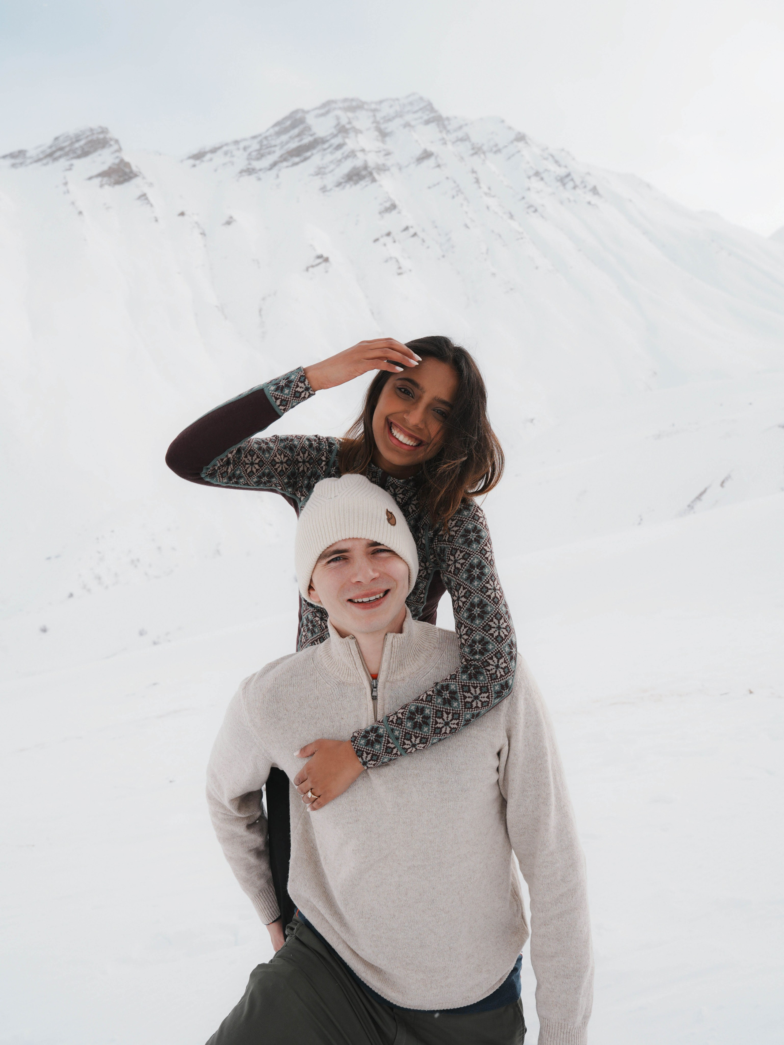 Couple portrait in snow in Caucasus mountains