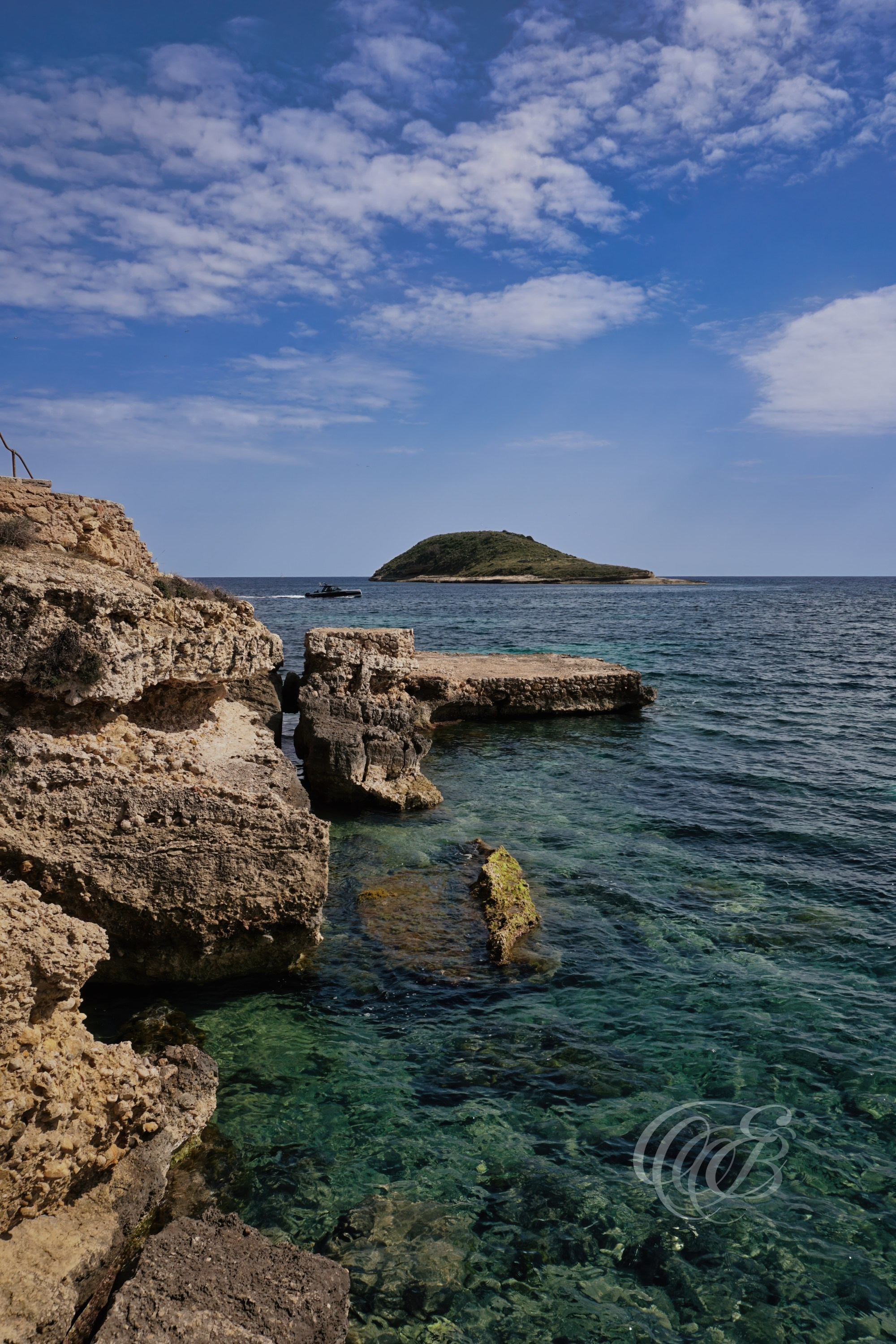 Rising above the Mediterranean coastline near Magaluf, the Torrenova cliffs form part of the rugged southwestern shoreline of Mallorca, where limestone formations meet the sea beneath open island skies. This coastal viewpoint reflects the dramatic geography and natural textures that define the Balearic landscape, shaped over centuries by wind, salt, and the movement of the sea. The scene carries both the strength and stillness of Mallorca’s coastal terrain, where light and stone exist in quiet balance. Eduardo Bartoli Photography.