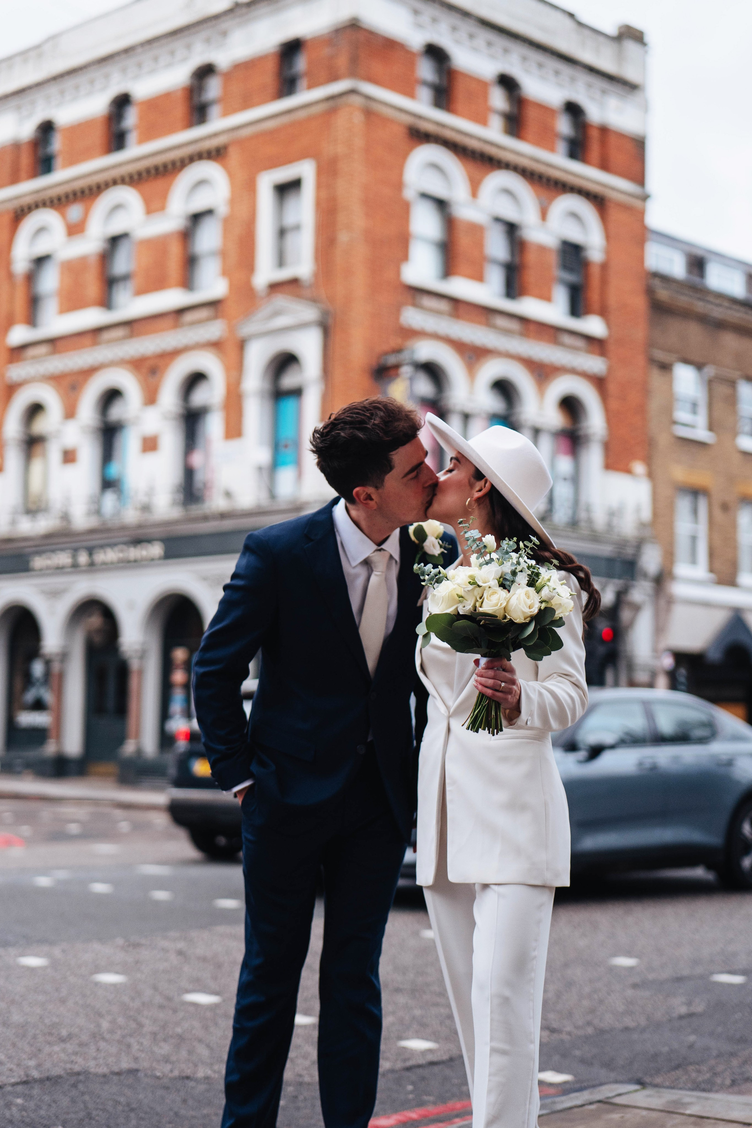 Stylish wedding in Islington, white women costume and white hat