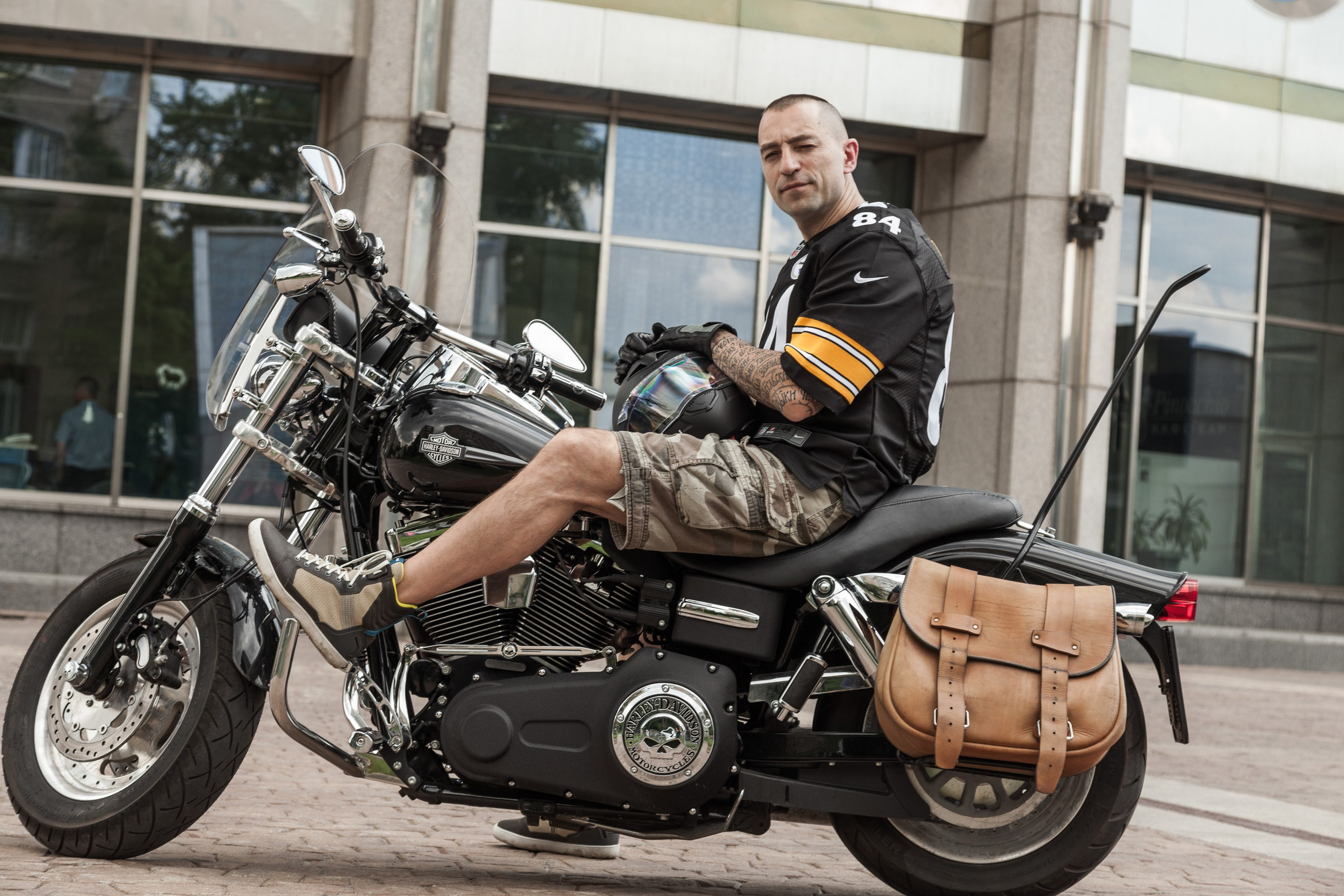Location portrait of a biker on a Harley Davidson motorcycle in city landscape - photographer Andrey Dunin