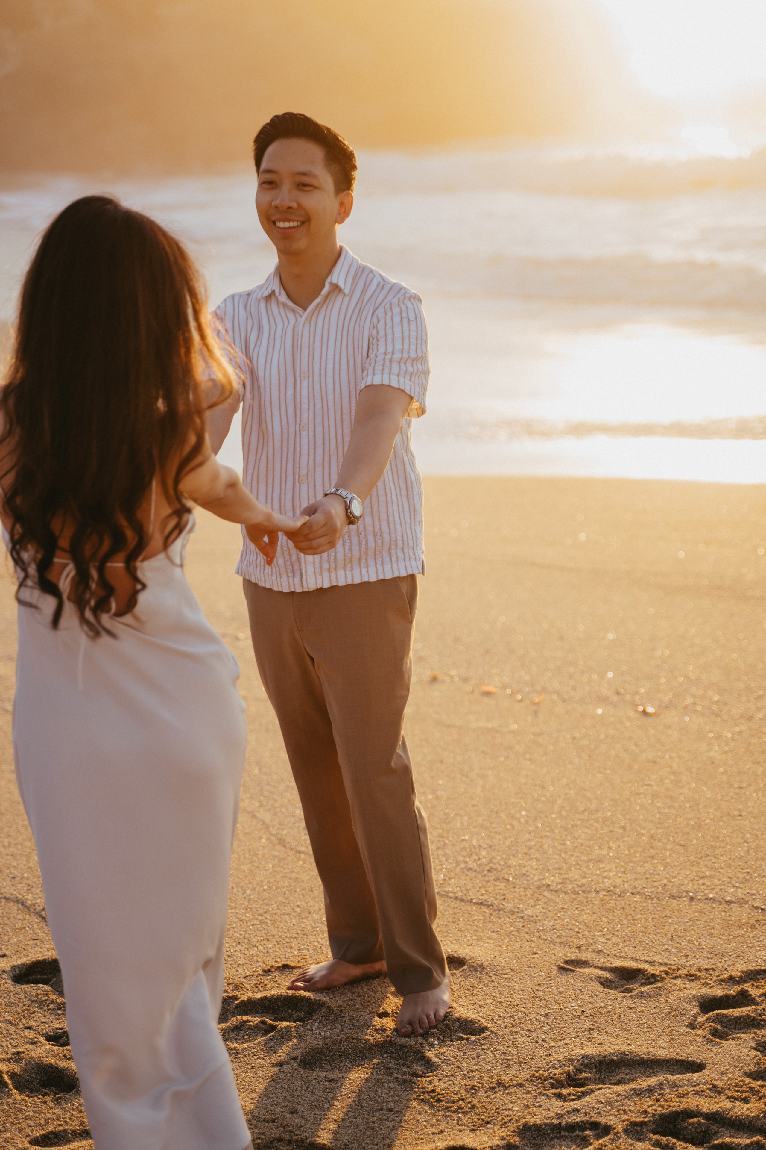 A photo shoot on the San Francisco beach at sunset. Engagement session. 