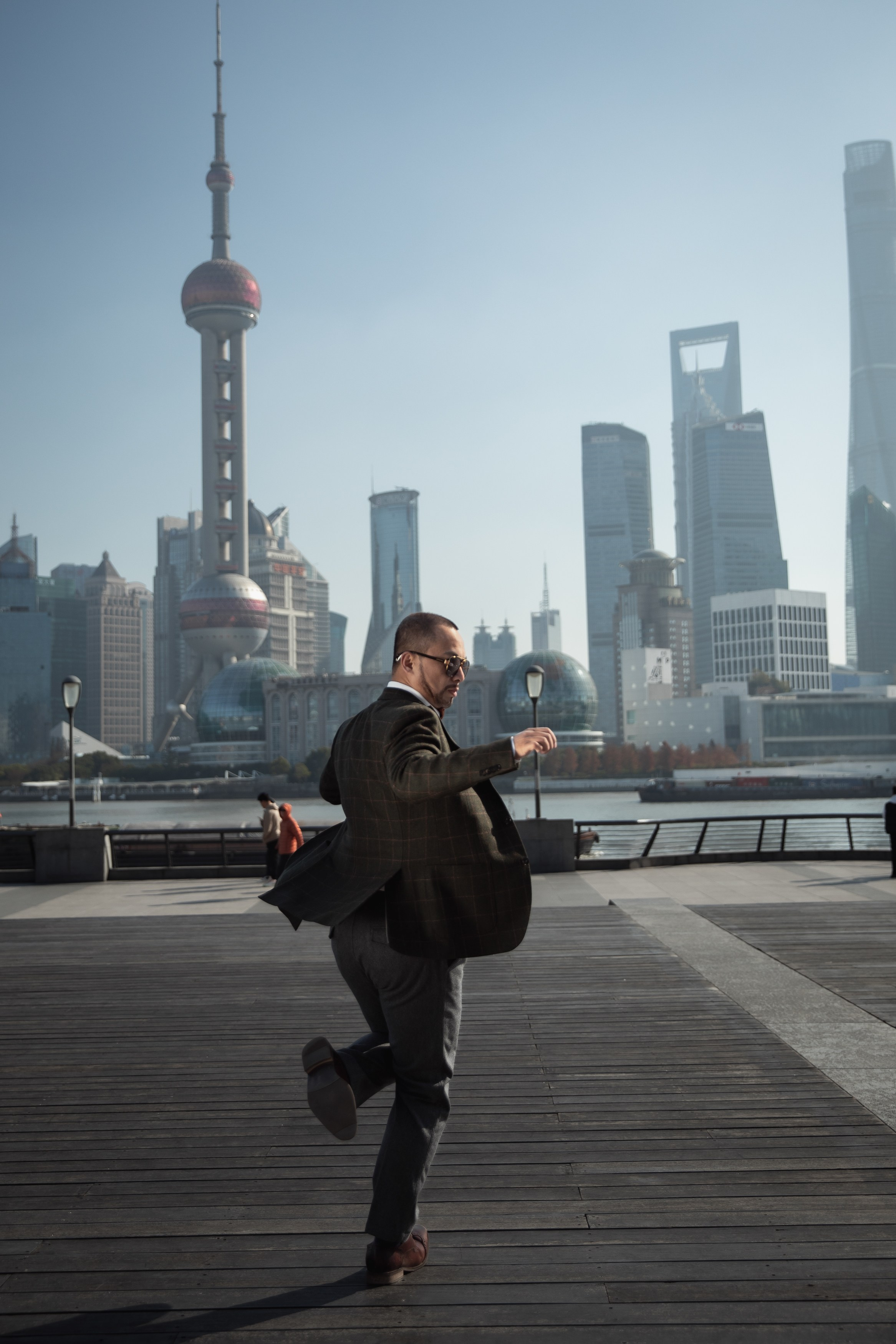 мужчина танцует на набережной Шанхая