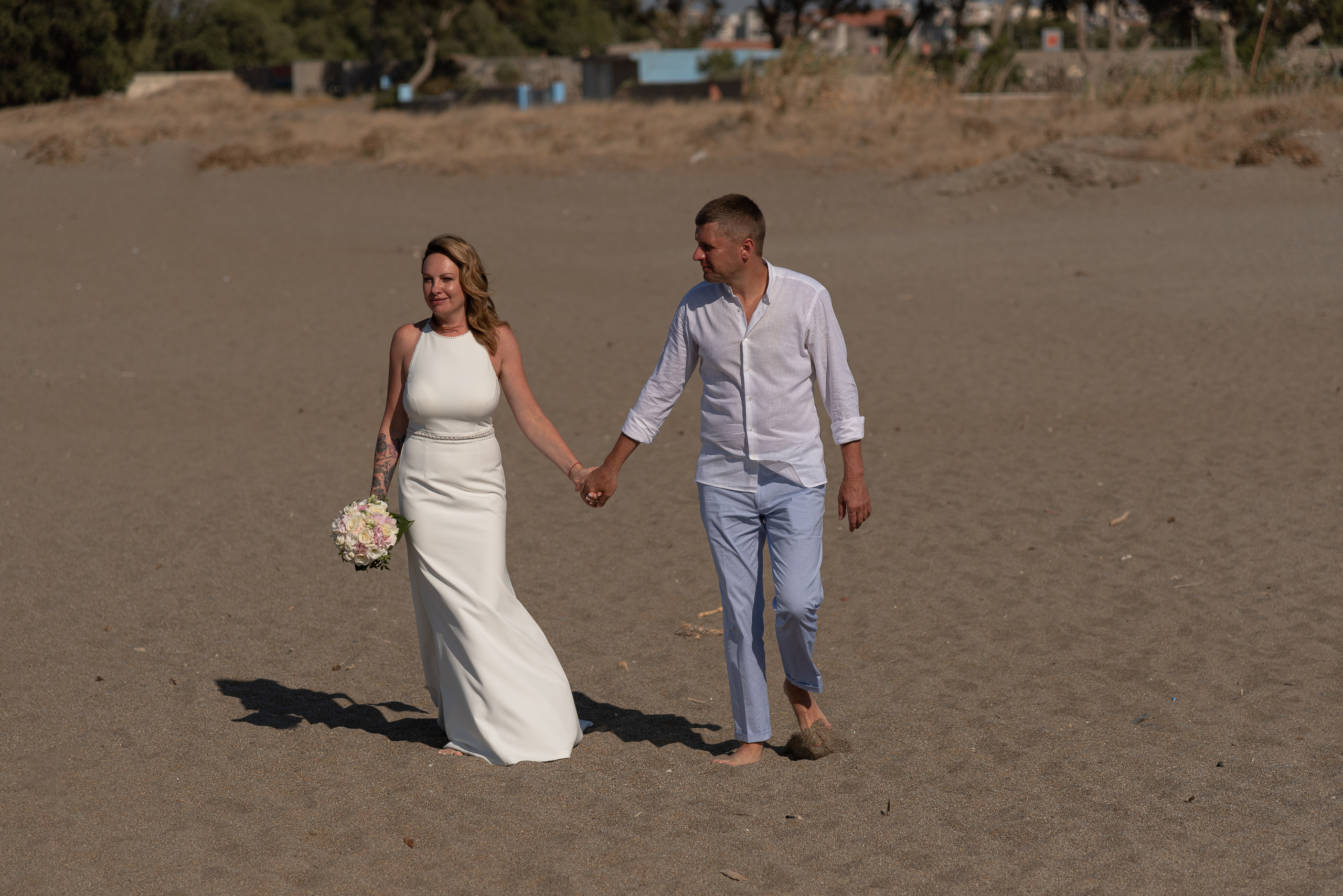 Wedding photo shoot in Heraklion on the beach couple walking