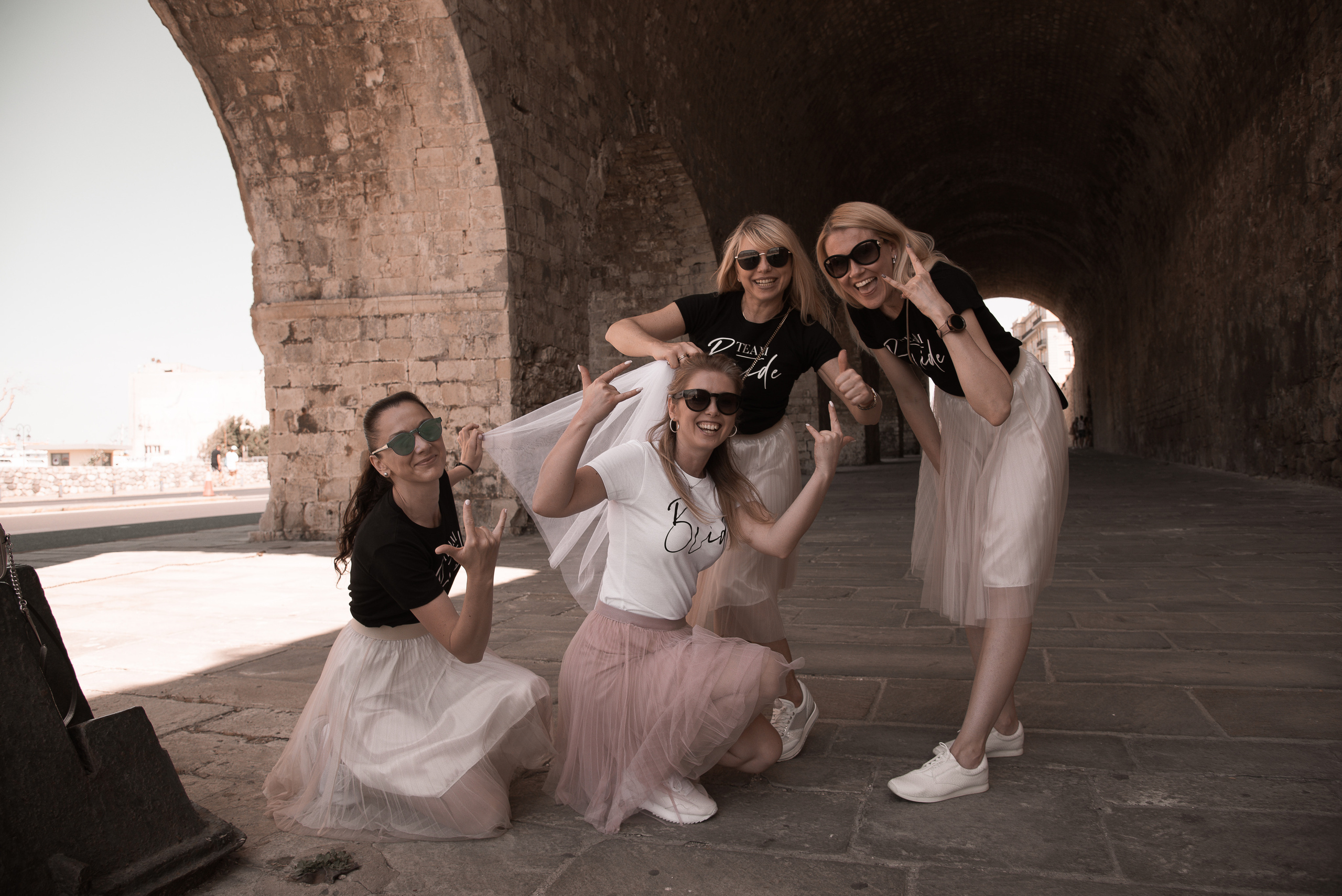 Wedding photo shoot in Crete in the old town bachelorette party in pink skirts