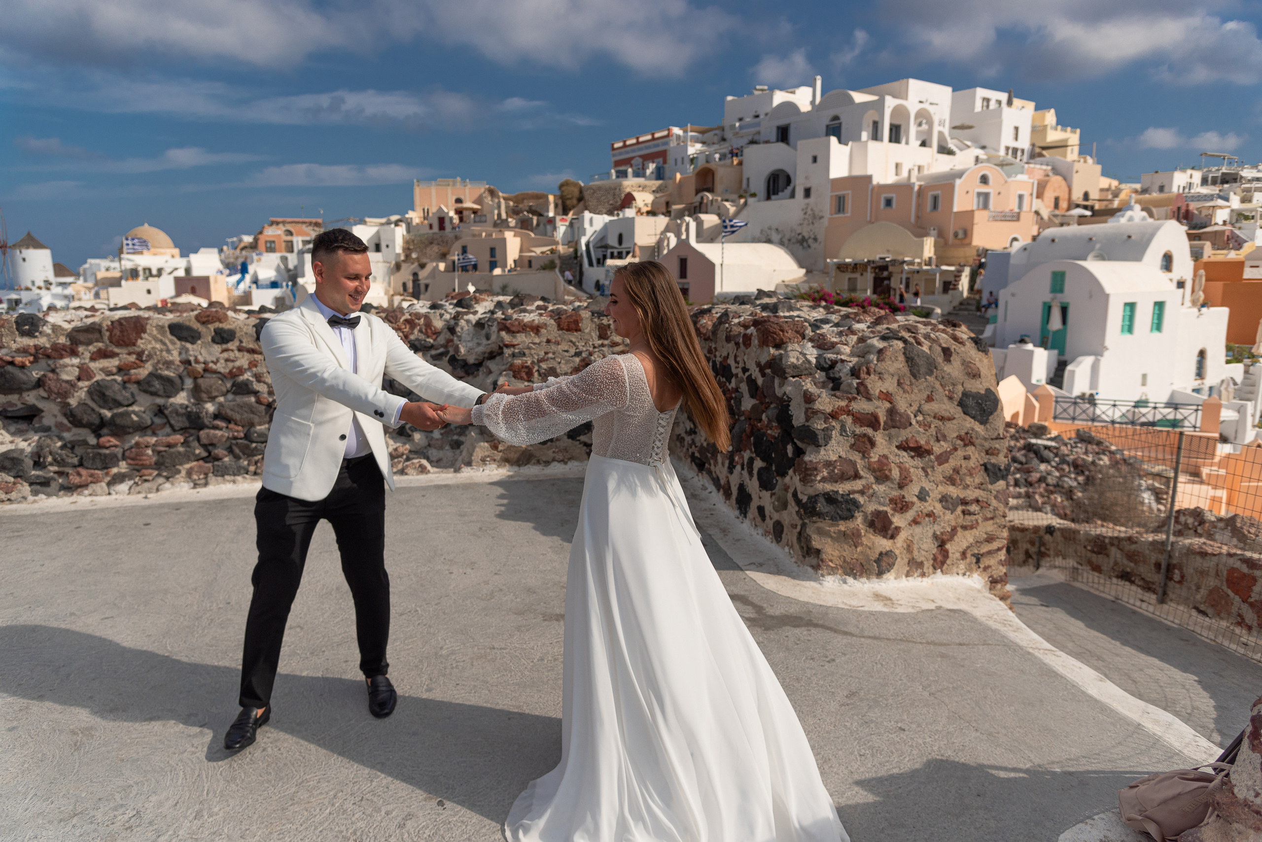 Bride and groom dancing in Santorini