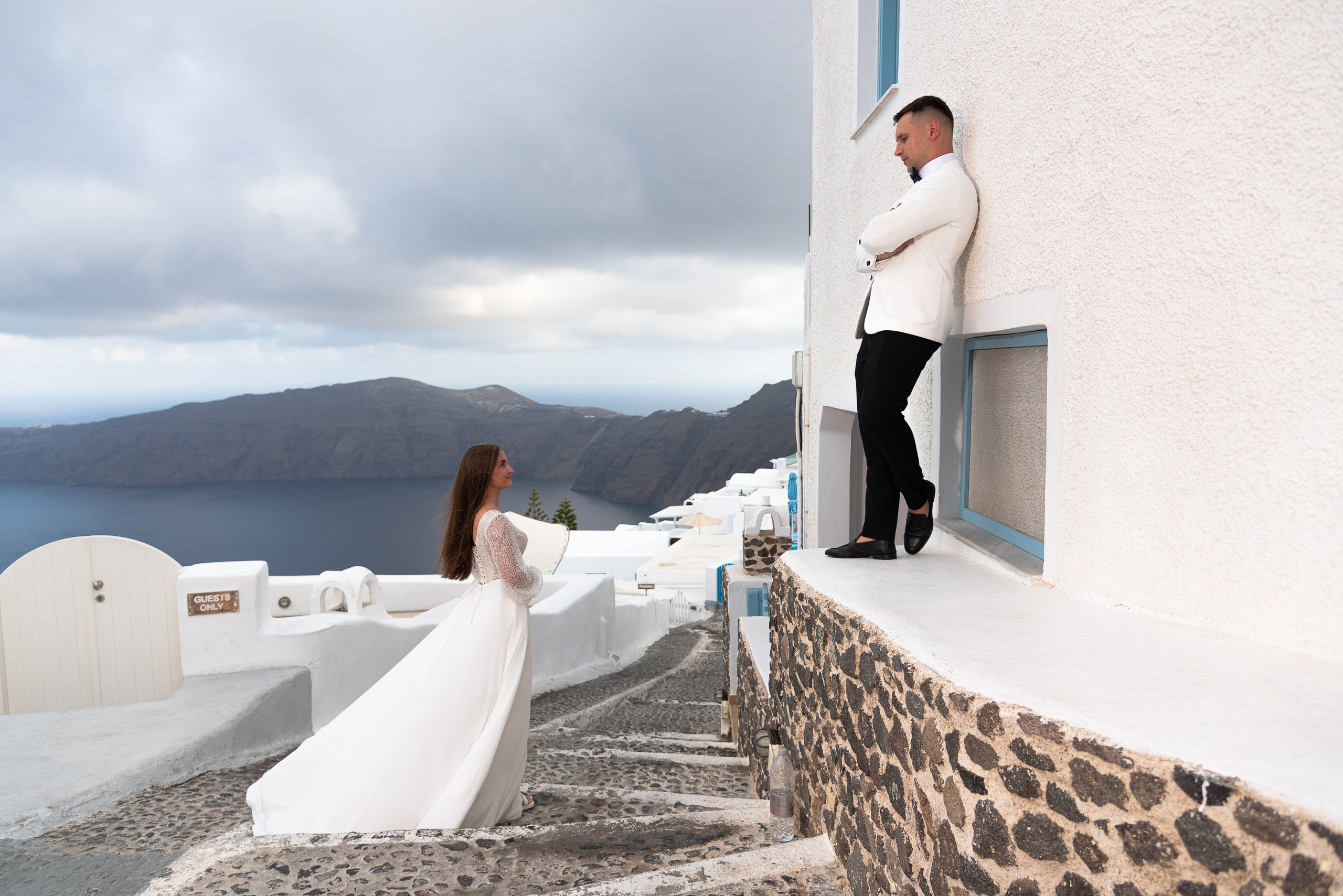 The bride and groom on the background of the white houses of Santorini