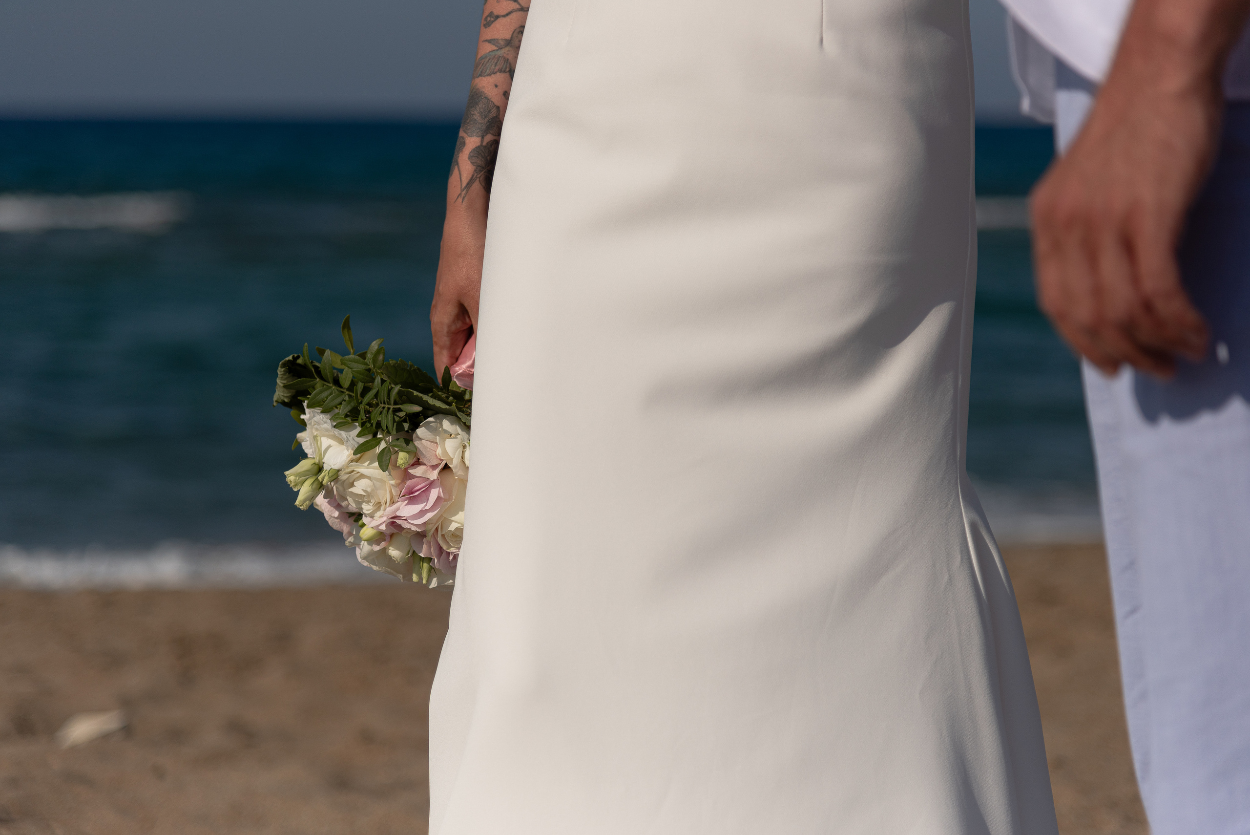 Wedding photo shoot in Heraklion on the beach couple walking