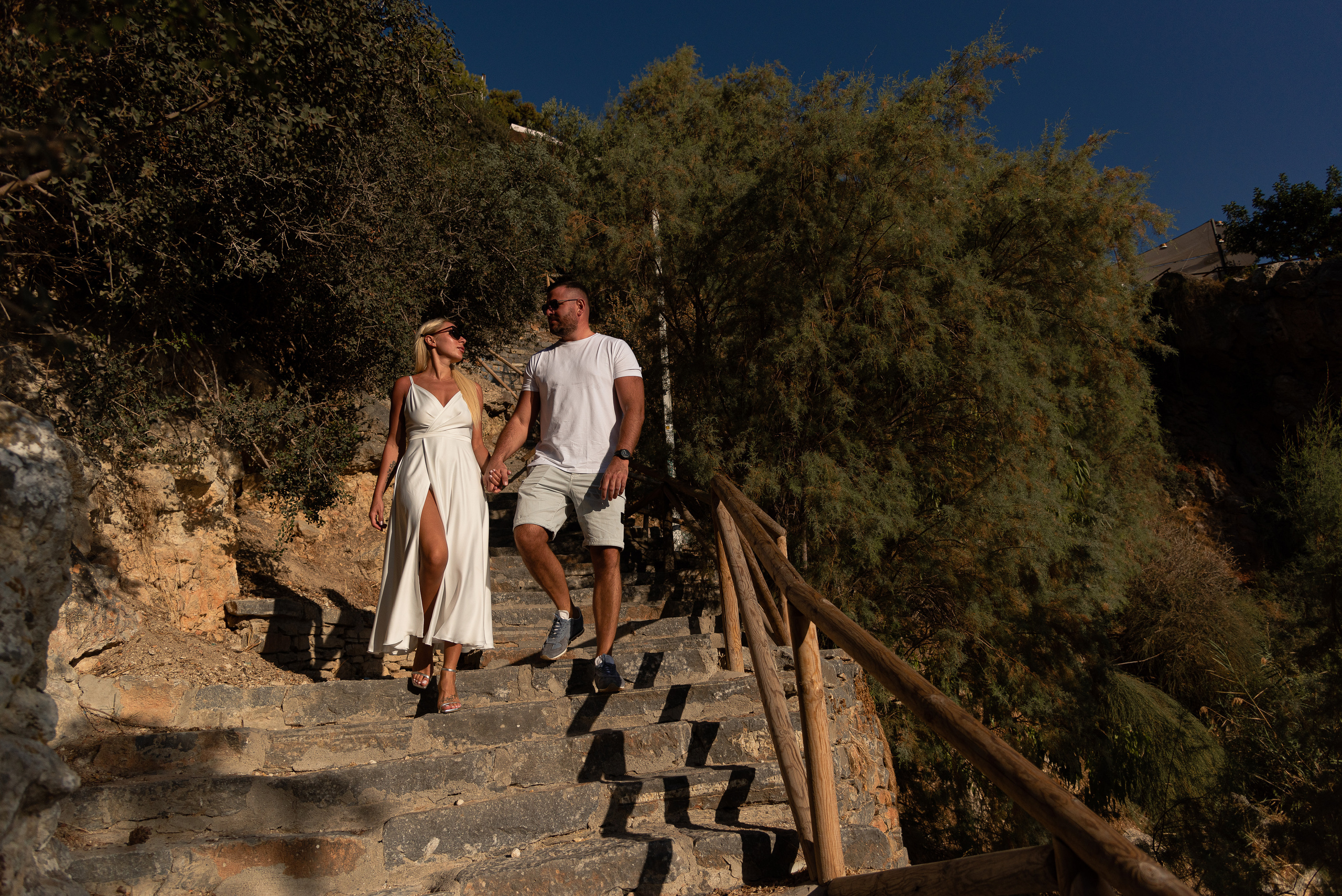 Beautiful couple walking down the stairs on the island of Crete