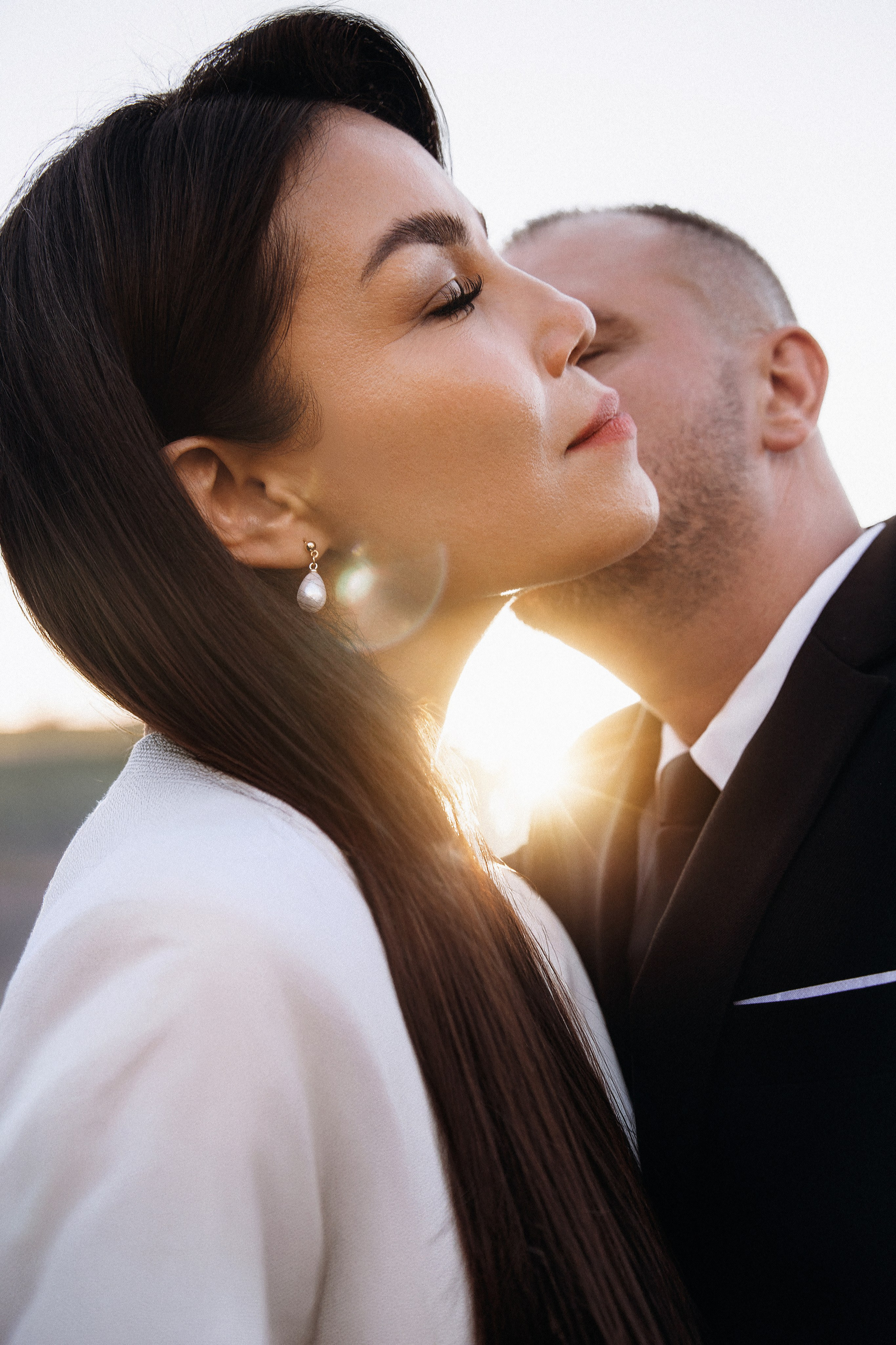 Romantic close-up of bride and groom embracing in Barcelona, Spain, natural and emotional destination wedding photography with intimate documentary style.