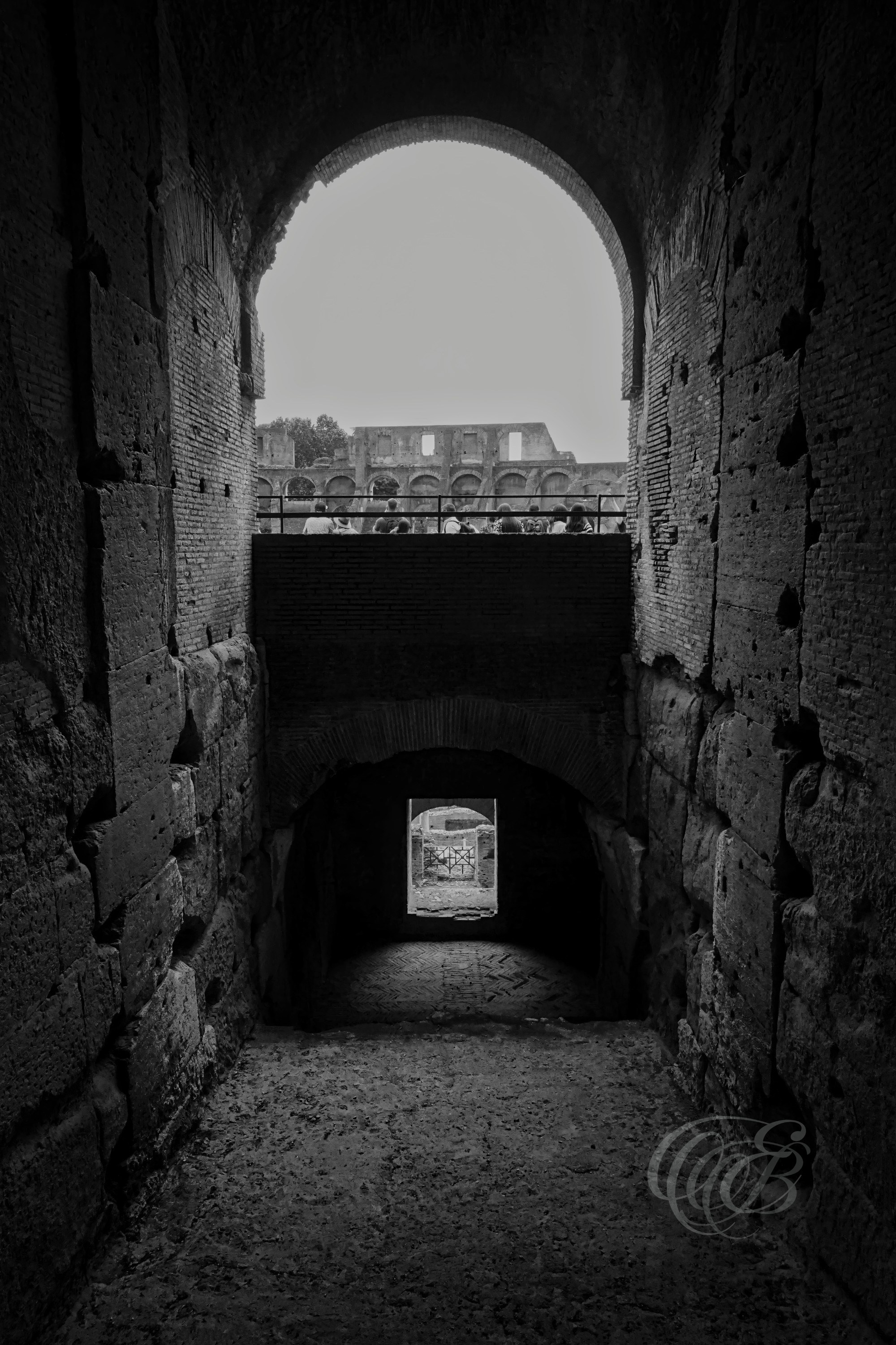 Rome, Italy — Lower Stairway of the Colosseum — Eduardo Bartoli Photography — Black and white photograph of a lower-level arched staircase inside the Colosseum, showcasing vaulted Roman architecture and historic stone passageways in Rome, Italy — Eduardo Bartoli Photography.