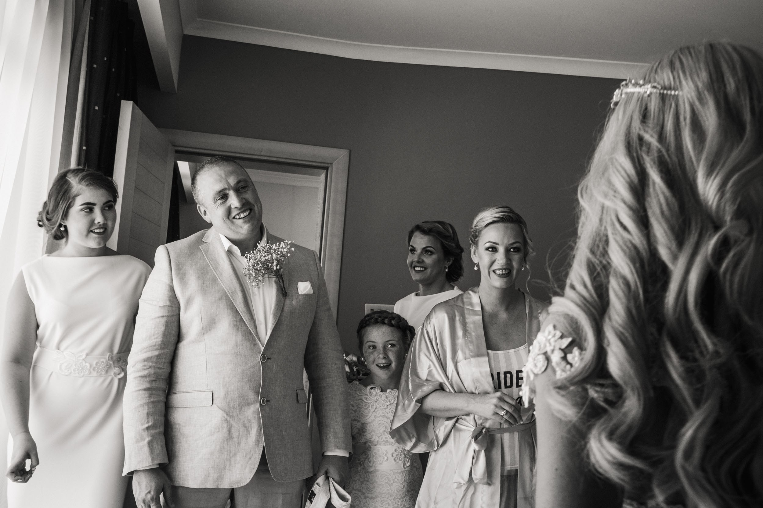 Father of the bride is looking at his daughter with love