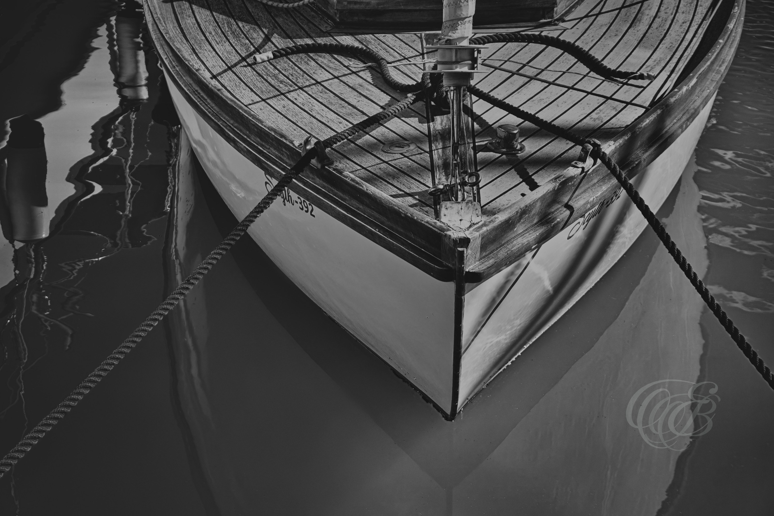 Maritime scenes have long been part of the visual identity of the Balearic Islands, where boats and harbors remain closely connected to the rhythm of coastal life. The Black and White Matte presentation enhances tonal detail and texture, creating a more classic interpretation of the scene while emphasizing the timeless character of a vintage boat resting by the docks. Eduardo Bartoli Photography.