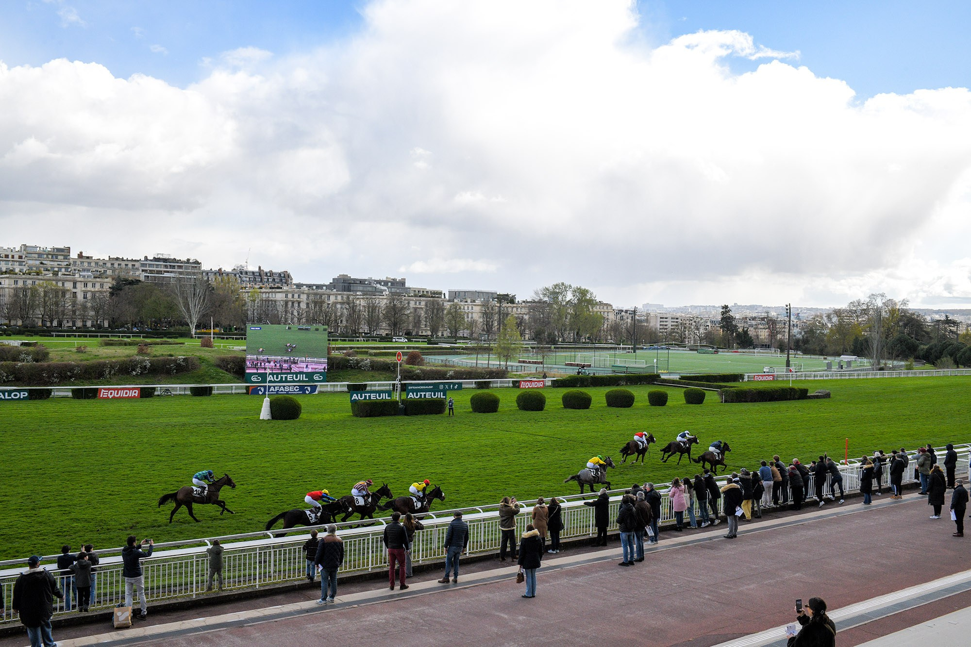 Horse race in progress at Hippodrome d’Auteuil racecourse in Paris