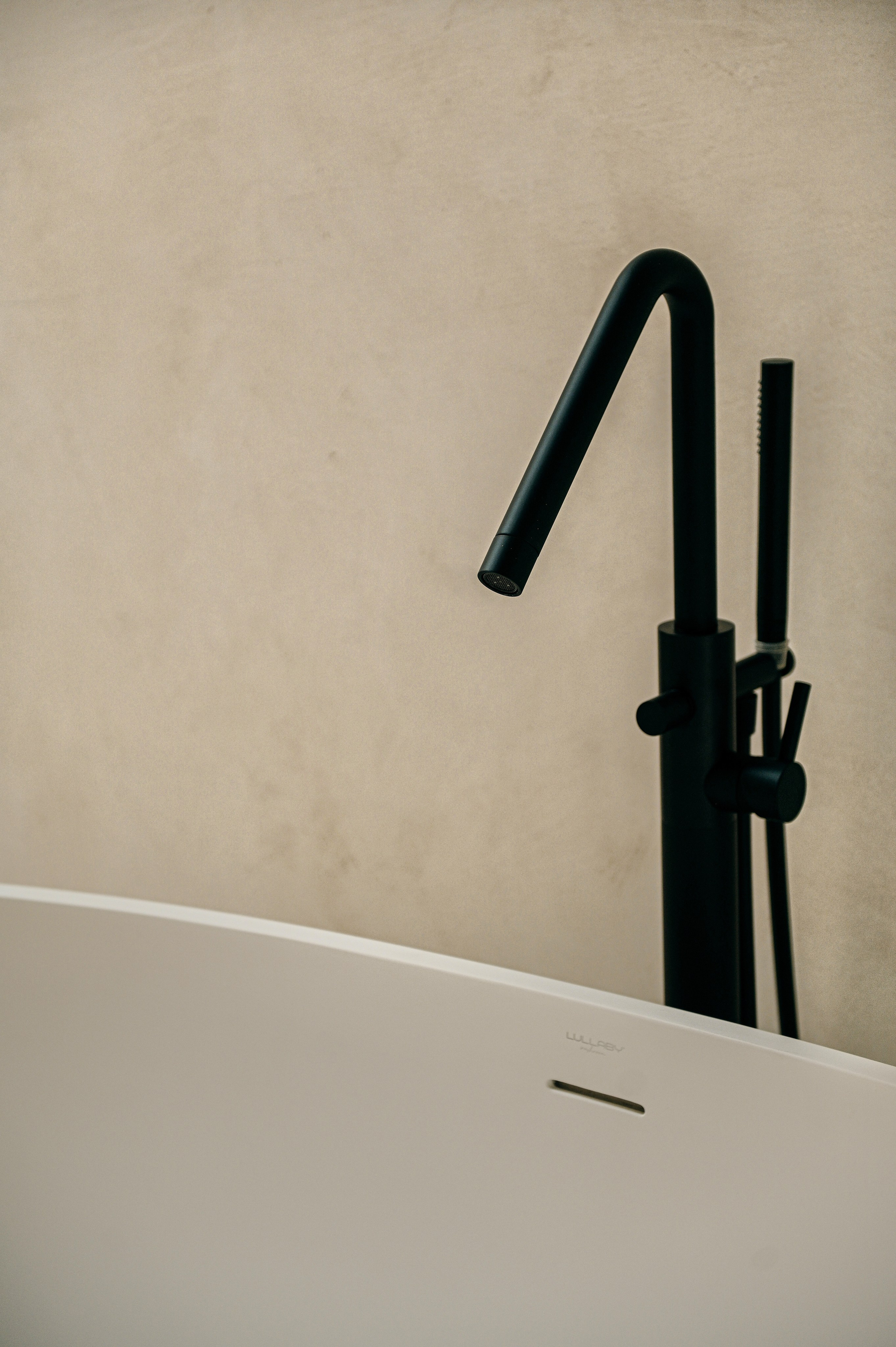 Minimalist freestanding bathtub with matte black faucet, modern bathroom interior design in Puglia.