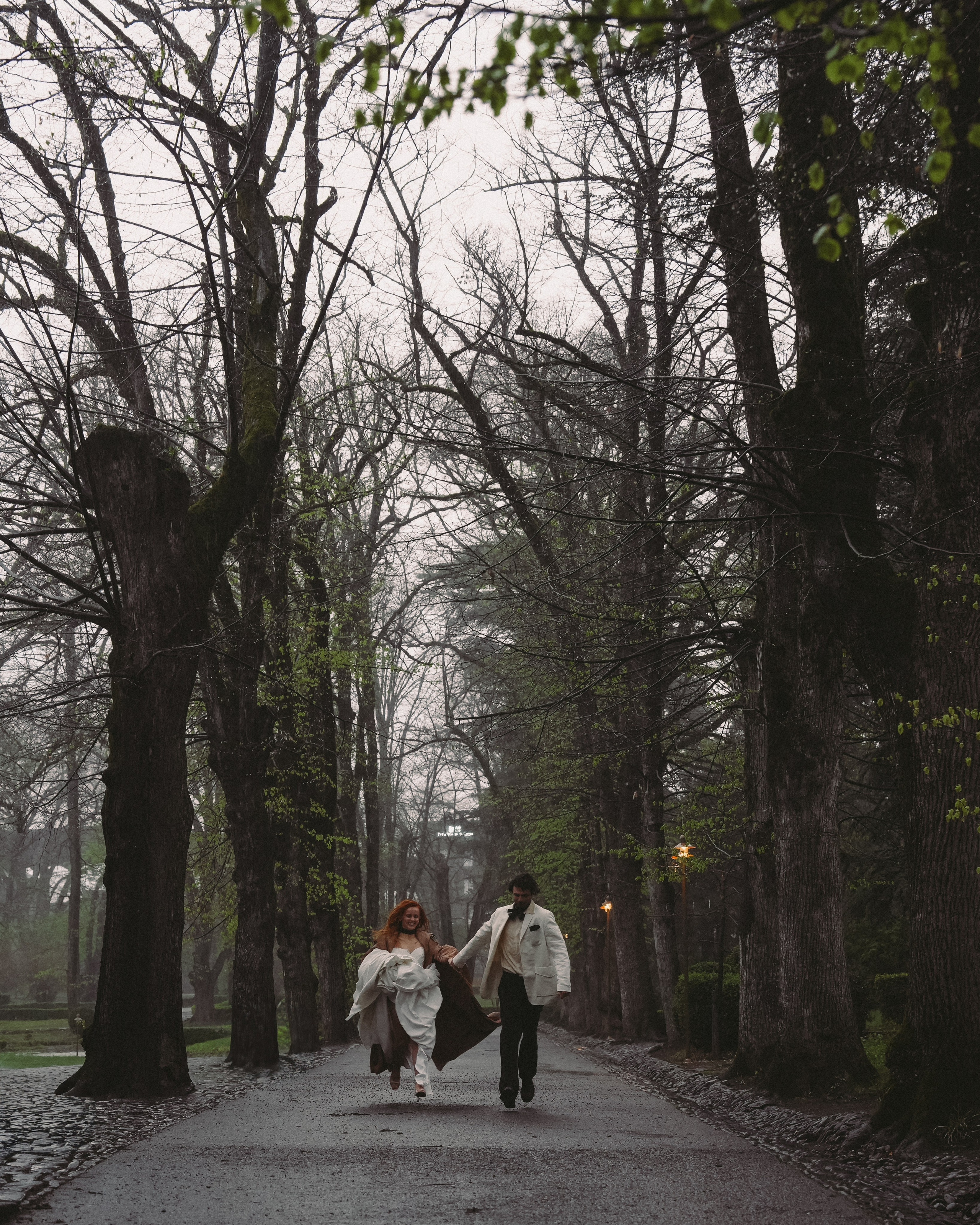 Bride and groom running through Tsinandali gardens in Kakheti