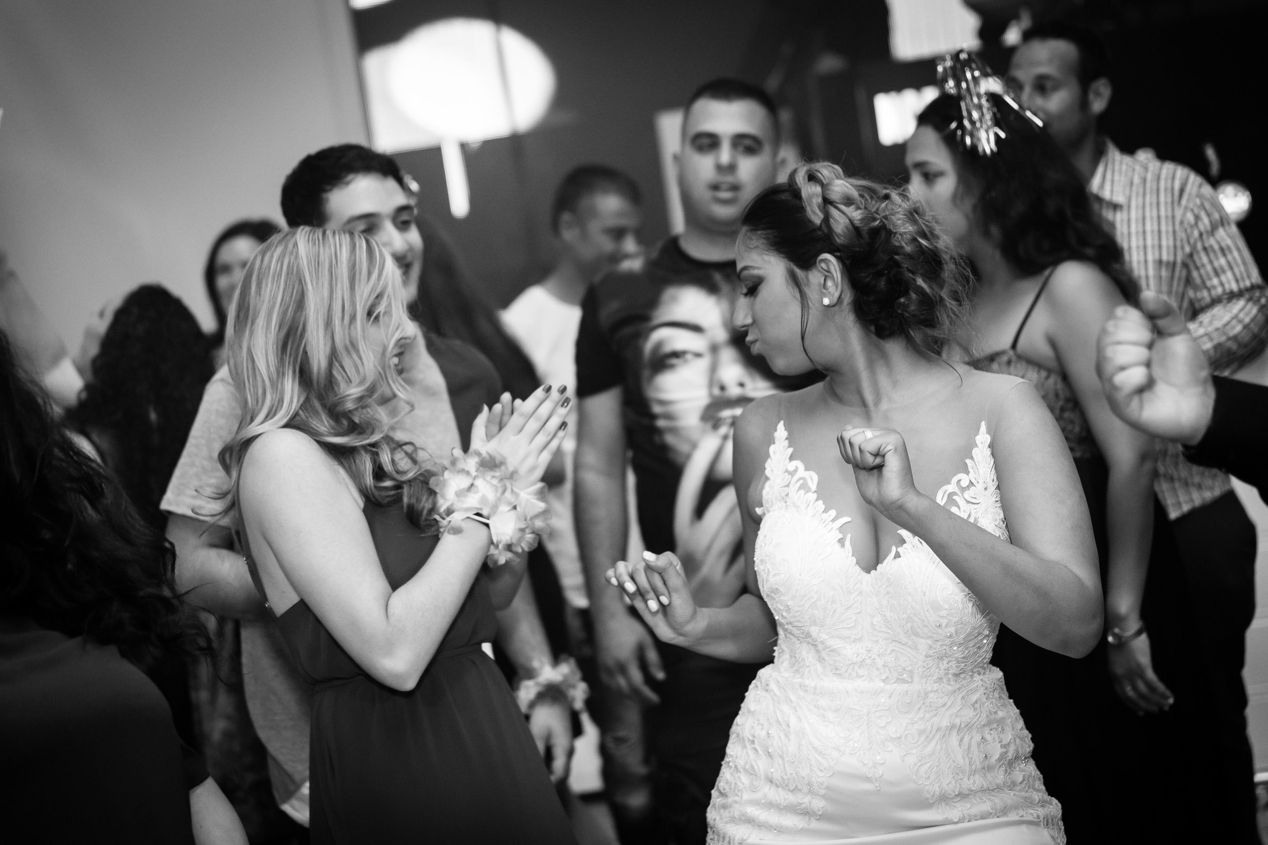 Bride and her bridesmaids dancing together during a lively wedding reception in Israel