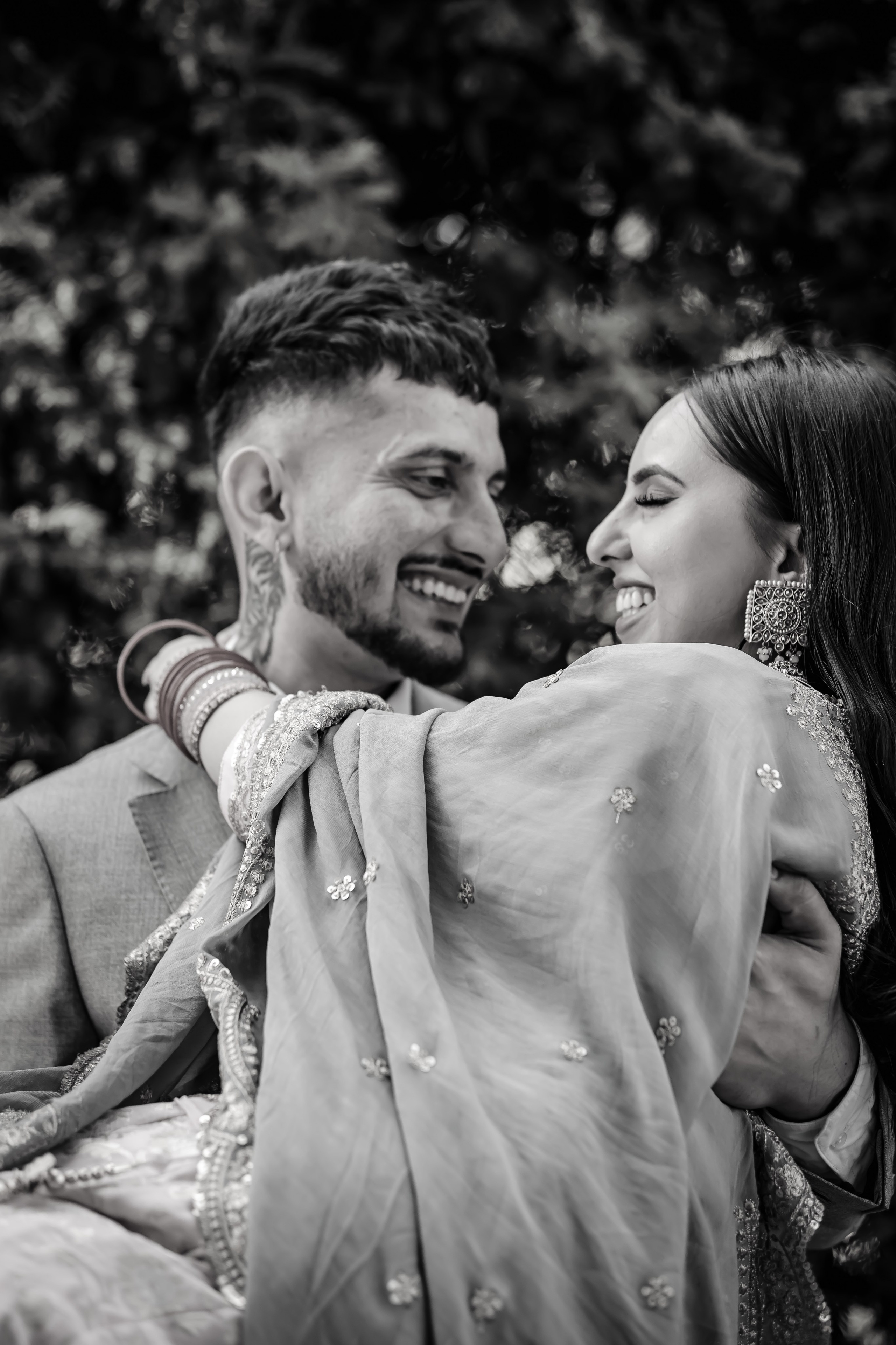 a man lifting a woman and smiling at her