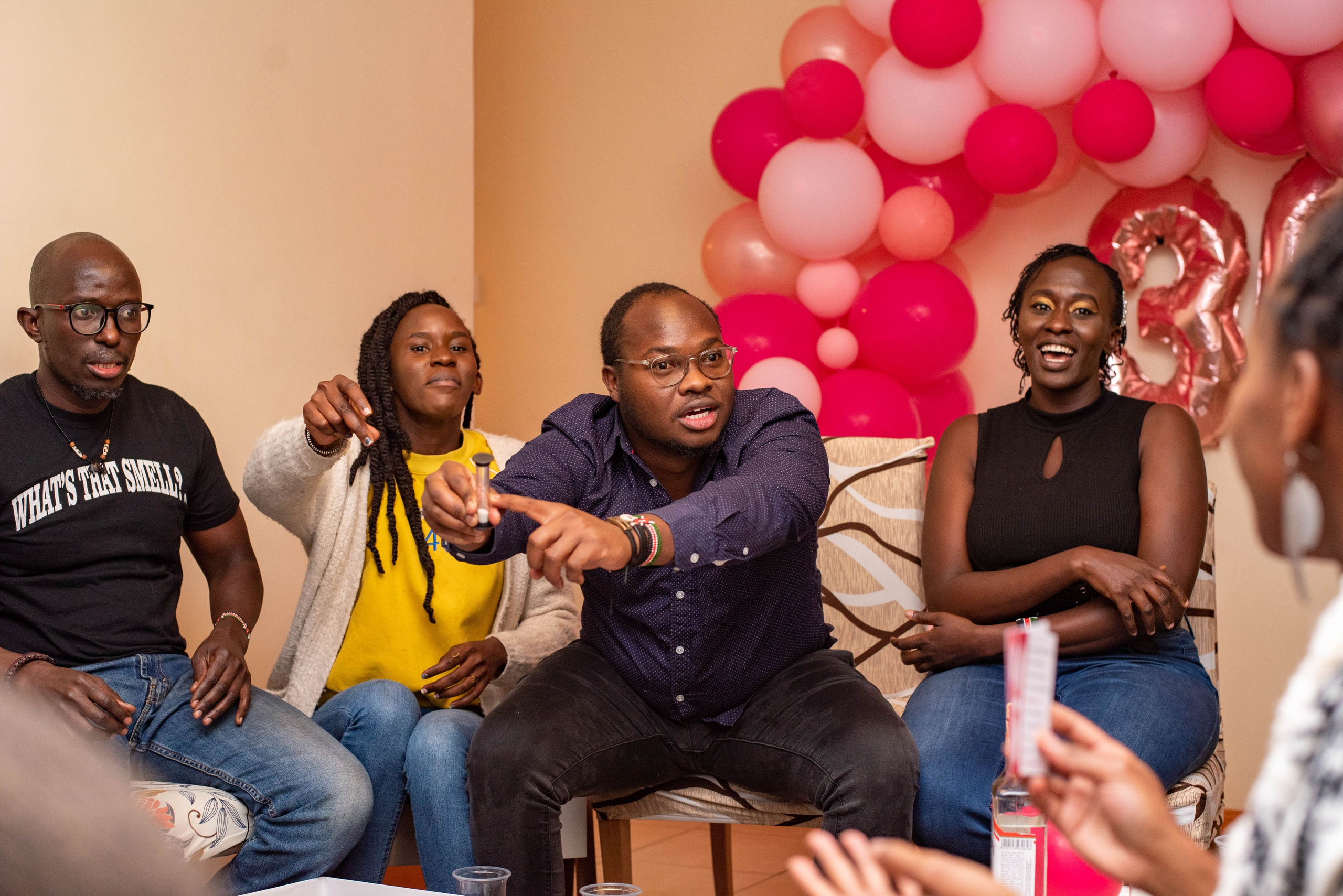 Friends playing board games at a Nairobi birthday celebration