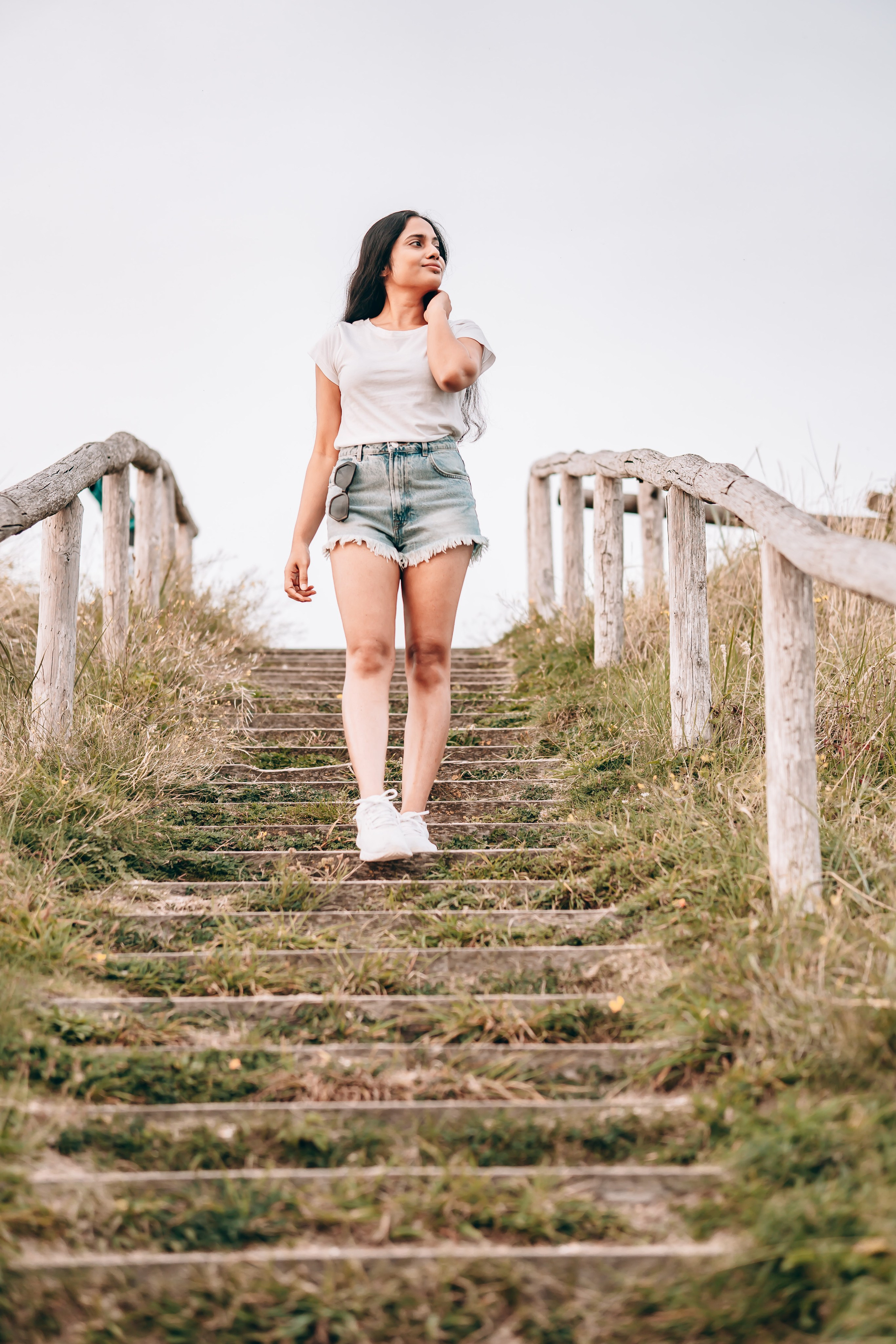 Woman walking down stairs close to the beach