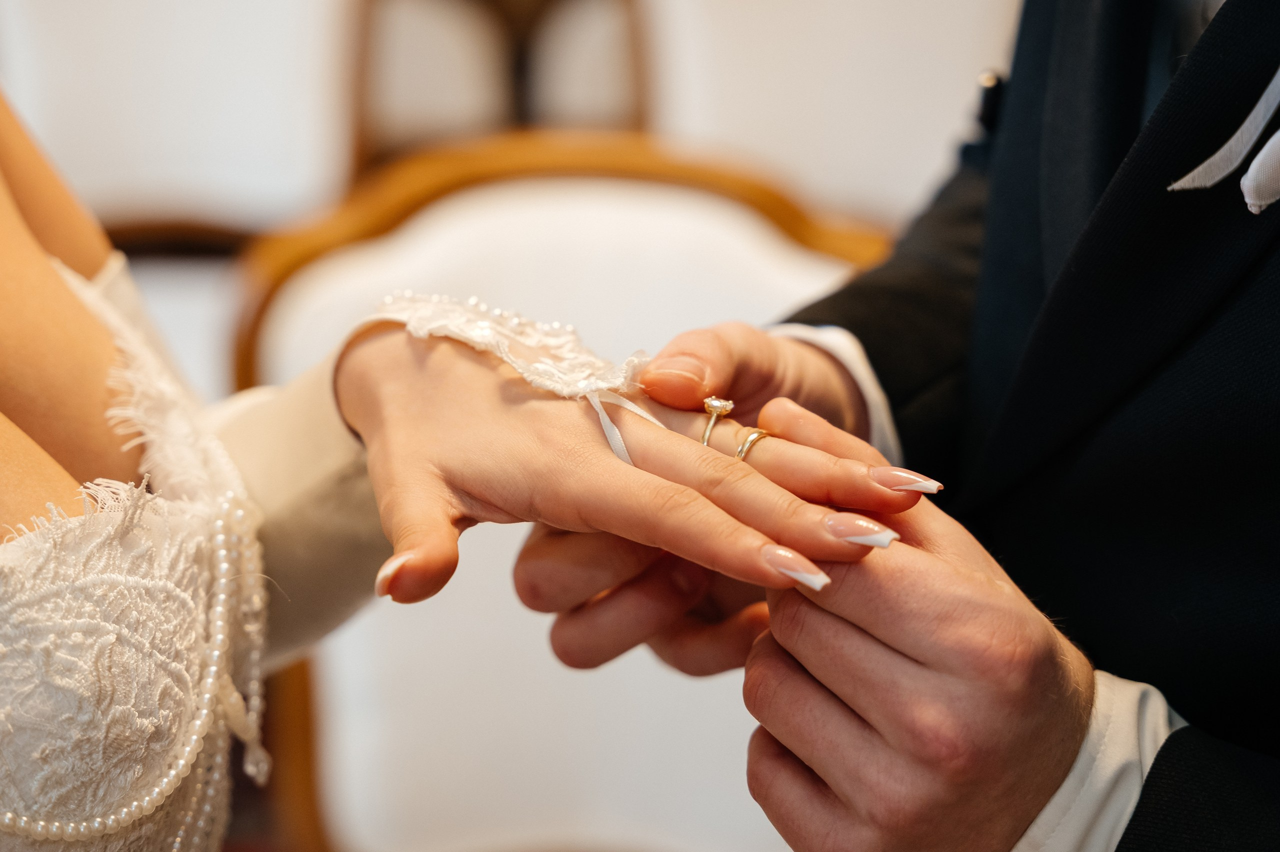 groom putting the ring on