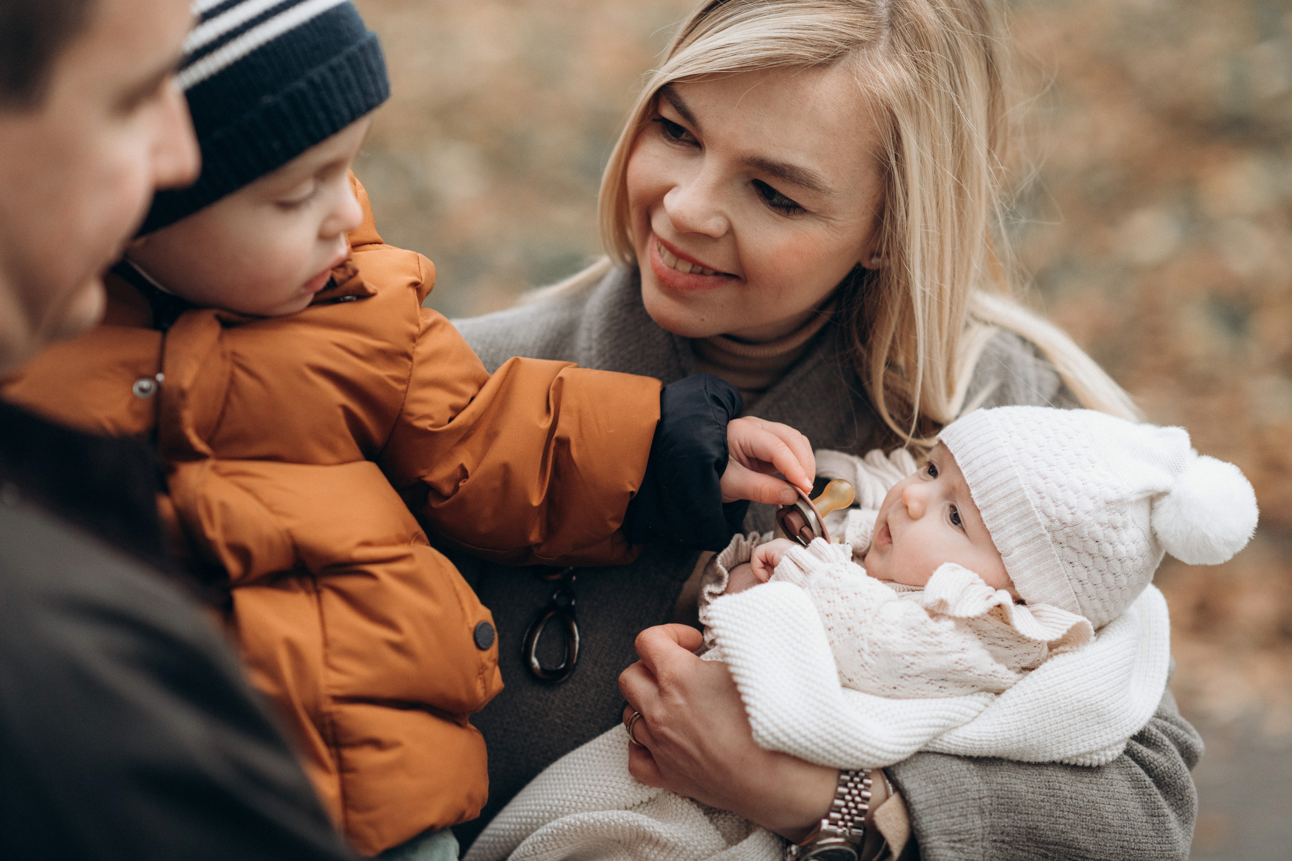 brother feeding his baby sister