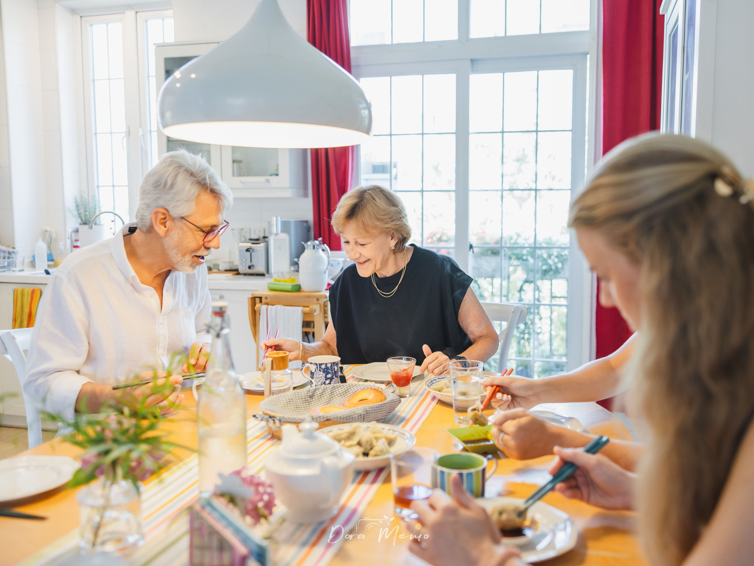  A family eating dumplings together around a table at home in Shanghai.