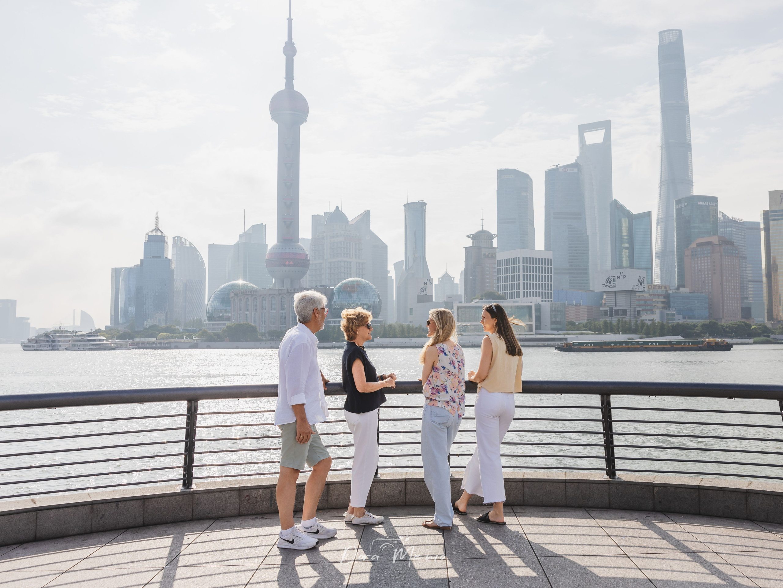 A German family walking together on the Bund during a morning family photo session in Shanghai.