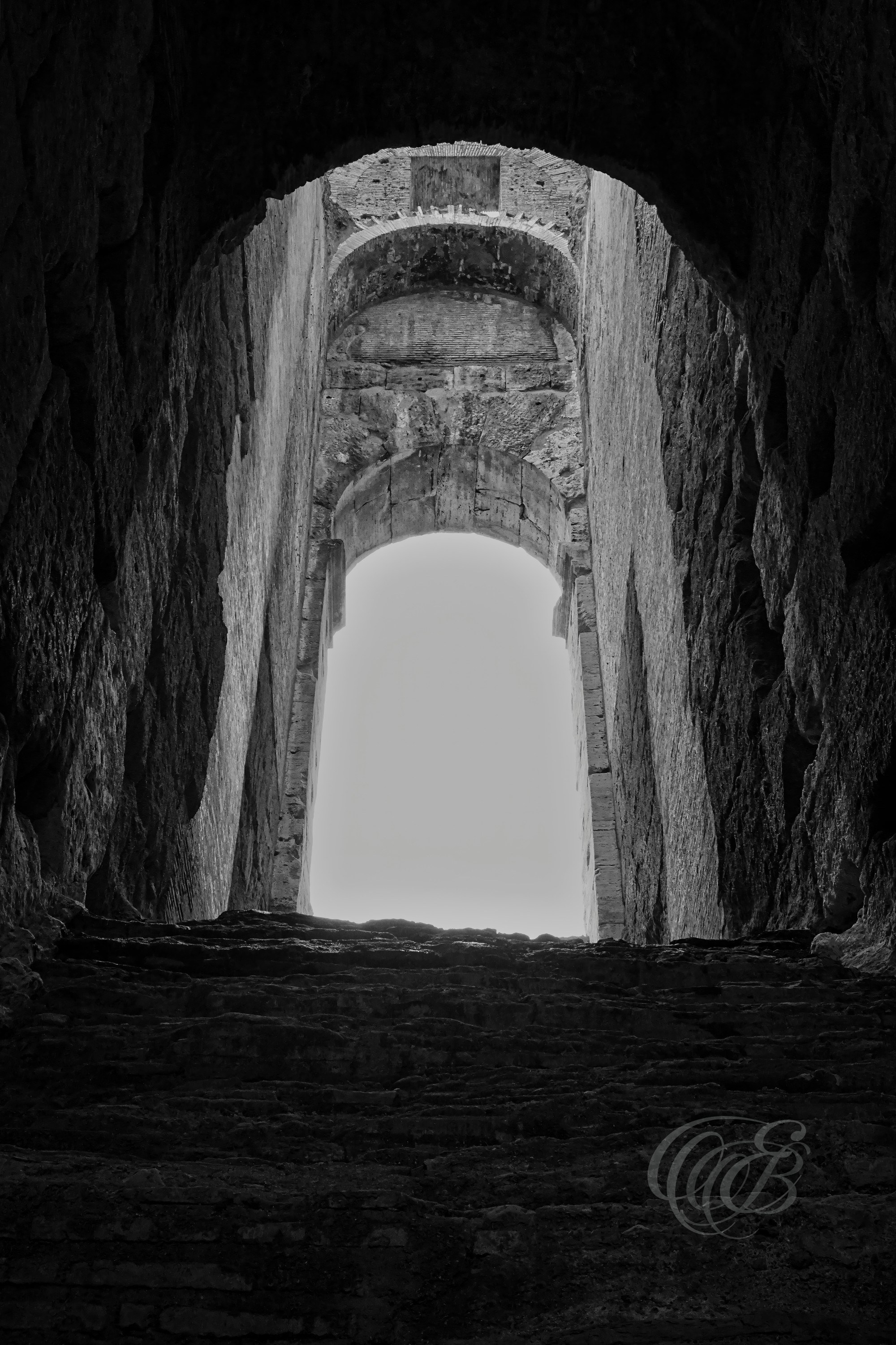Rome, Italy — Upper Archway of the Colosseum — Eduardo Bartoli Photography — Black and white photograph of an upper-level archway inside the Colosseum, showing historic Roman architecture, stone textures, and views toward the interior of the ancient amphitheater in Rome, Italy — Eduardo Bartoli Photography.