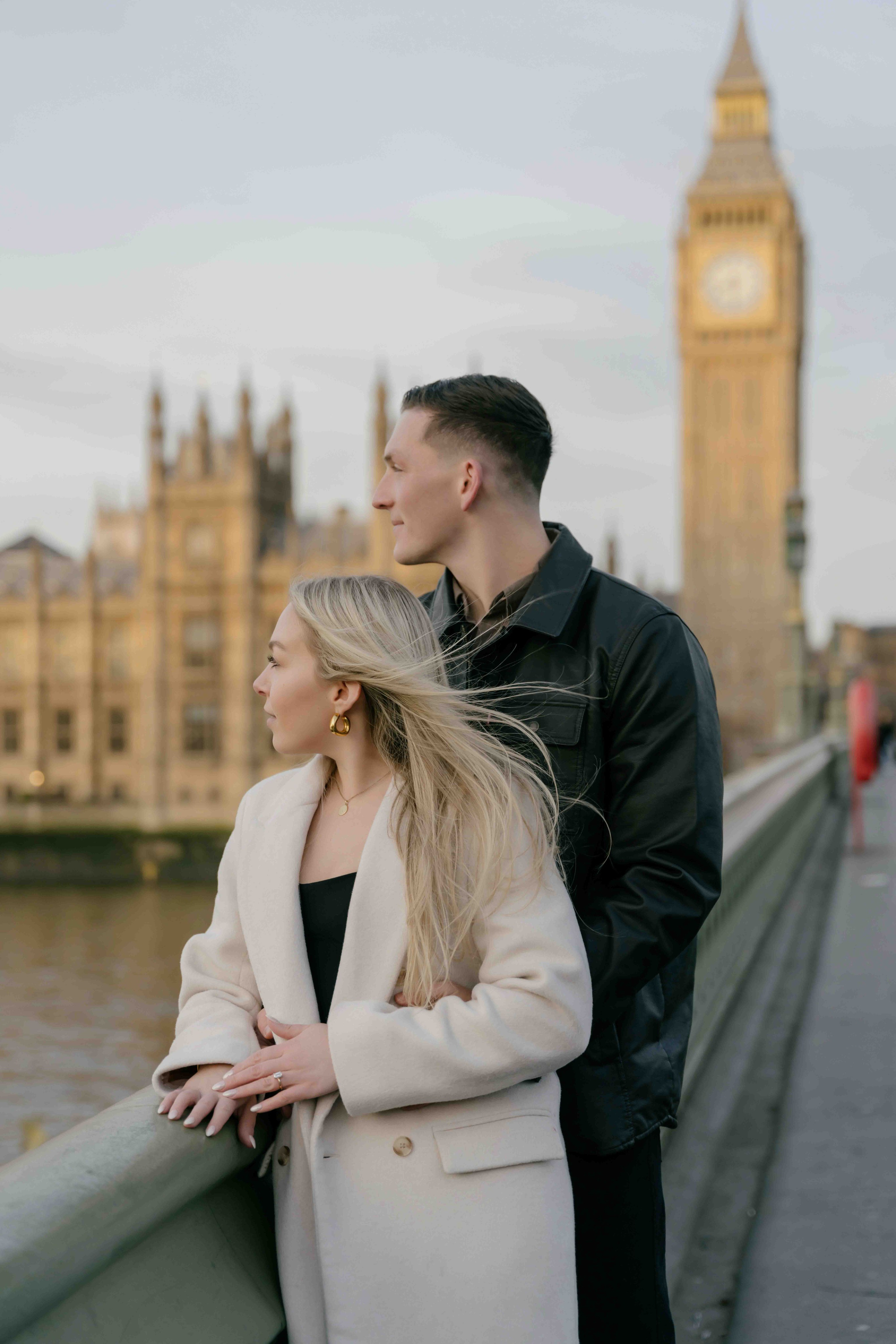 Romantic couple embracing in Westminster London with Big Ben sunrise engagement