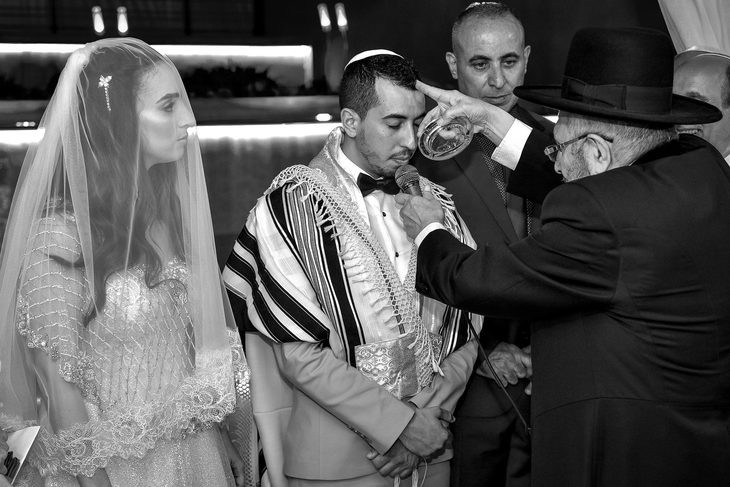 Aviad receives a traditional blessing from the rabbi beneath the chuppah