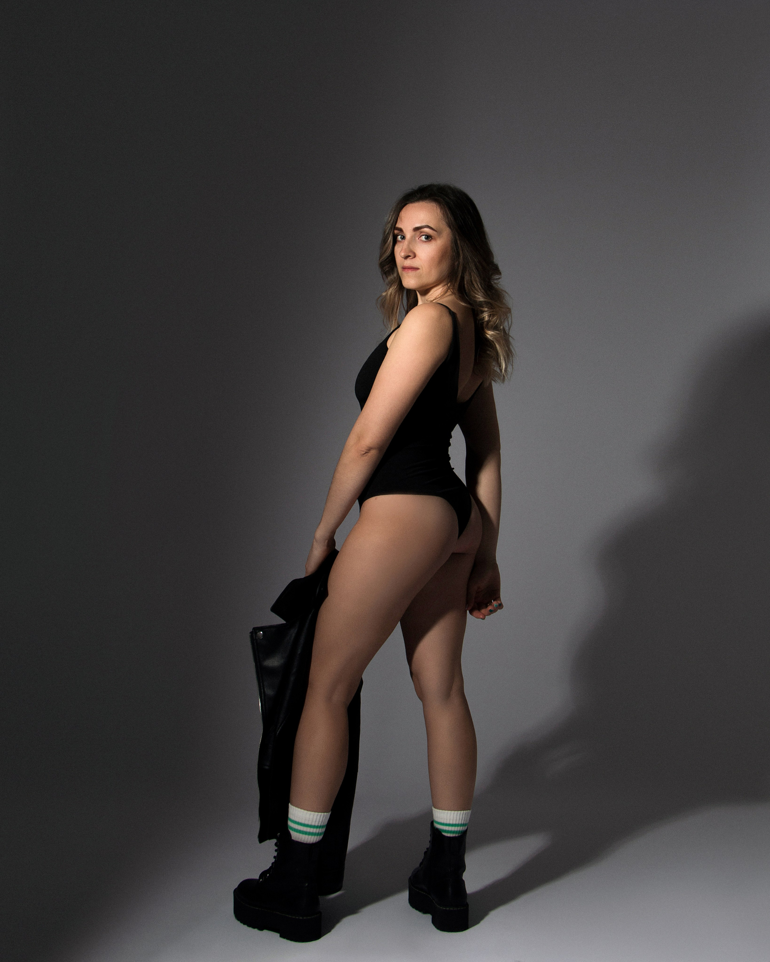 Studioaufnahme im klaren Licht – Frau mit Lederjacke und zurückhaltendem Stil