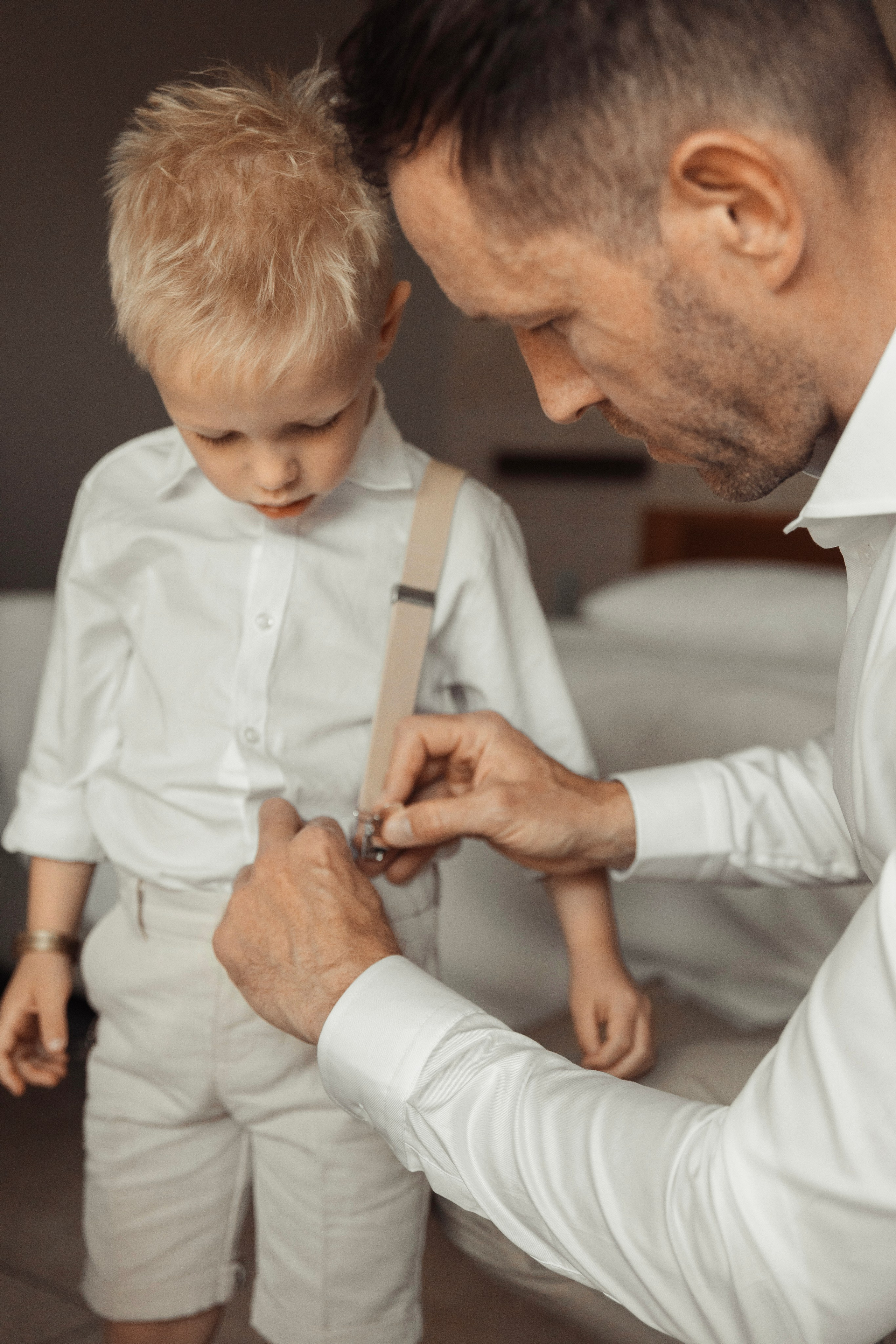 Groom is helping his son as getting ready for the wedding. Rhodes, Greece