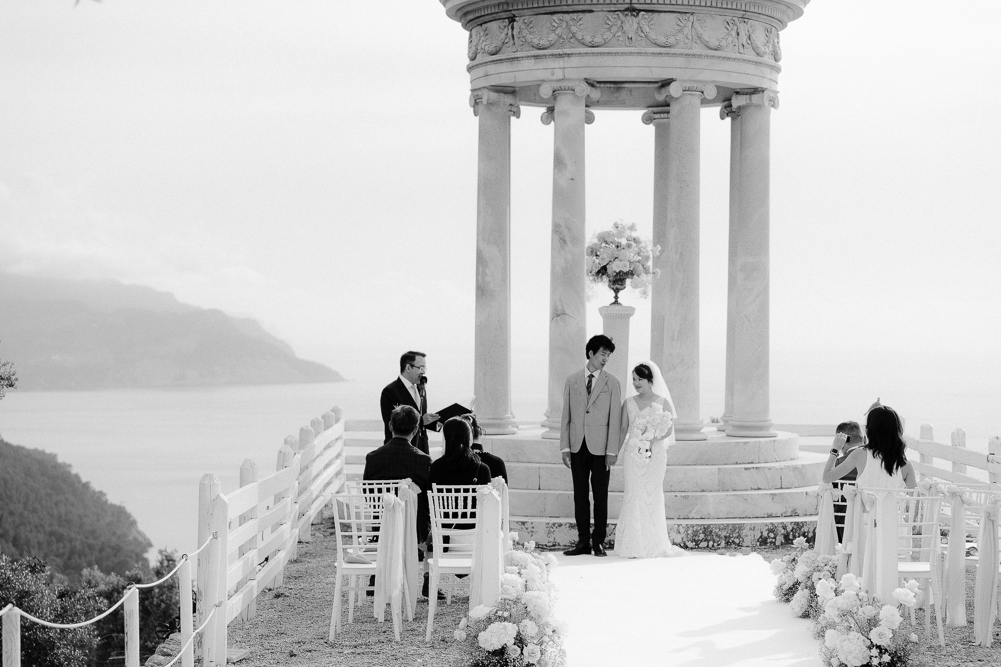 Bride and groom listening to their Mallorca wedding celebrant at the Son Marroig temple