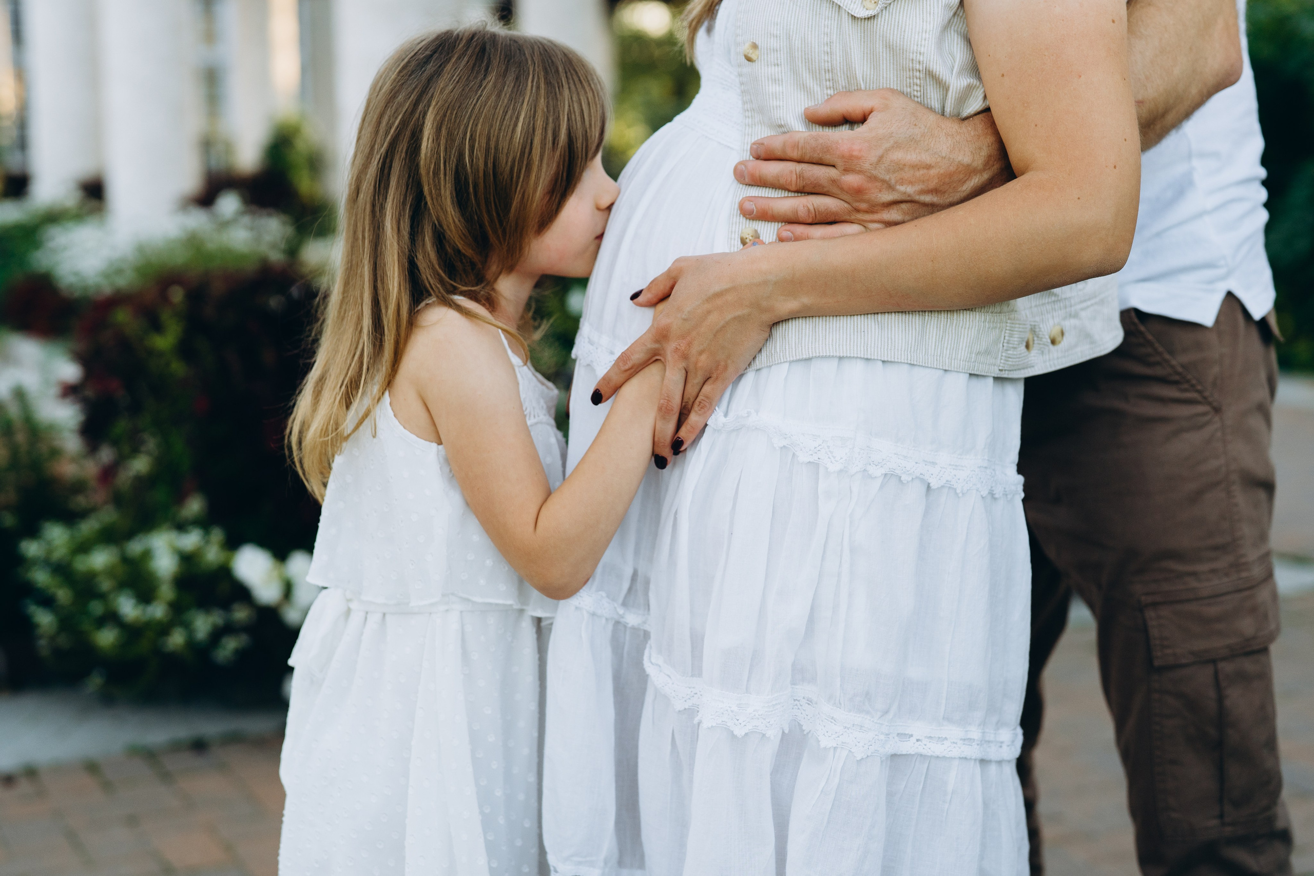 daughter kisses pregnant belly beautiful photo shoot in winnipeg