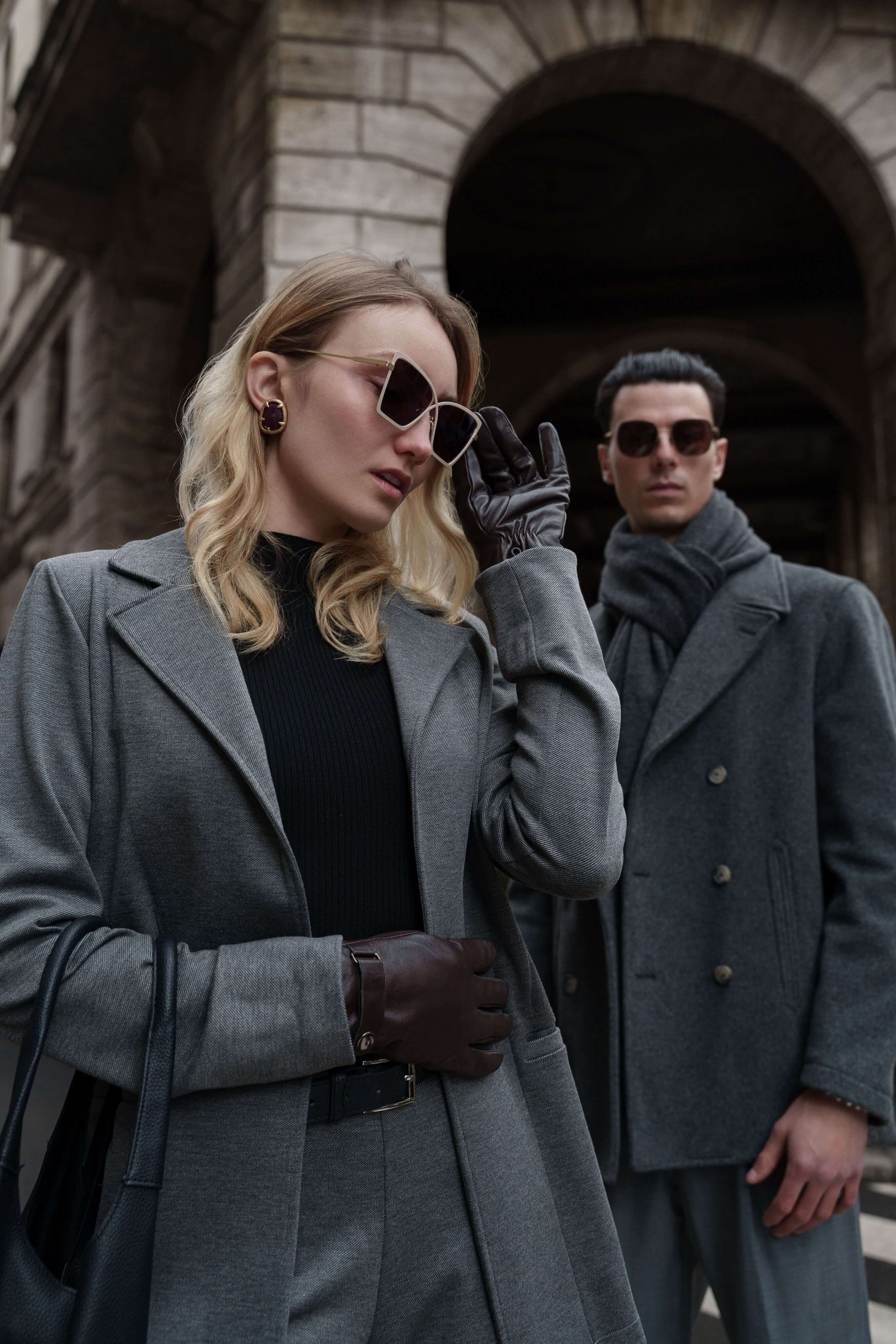 Couple posing during brand photoshoot in Italy – editorial street fashion with eyewear focus