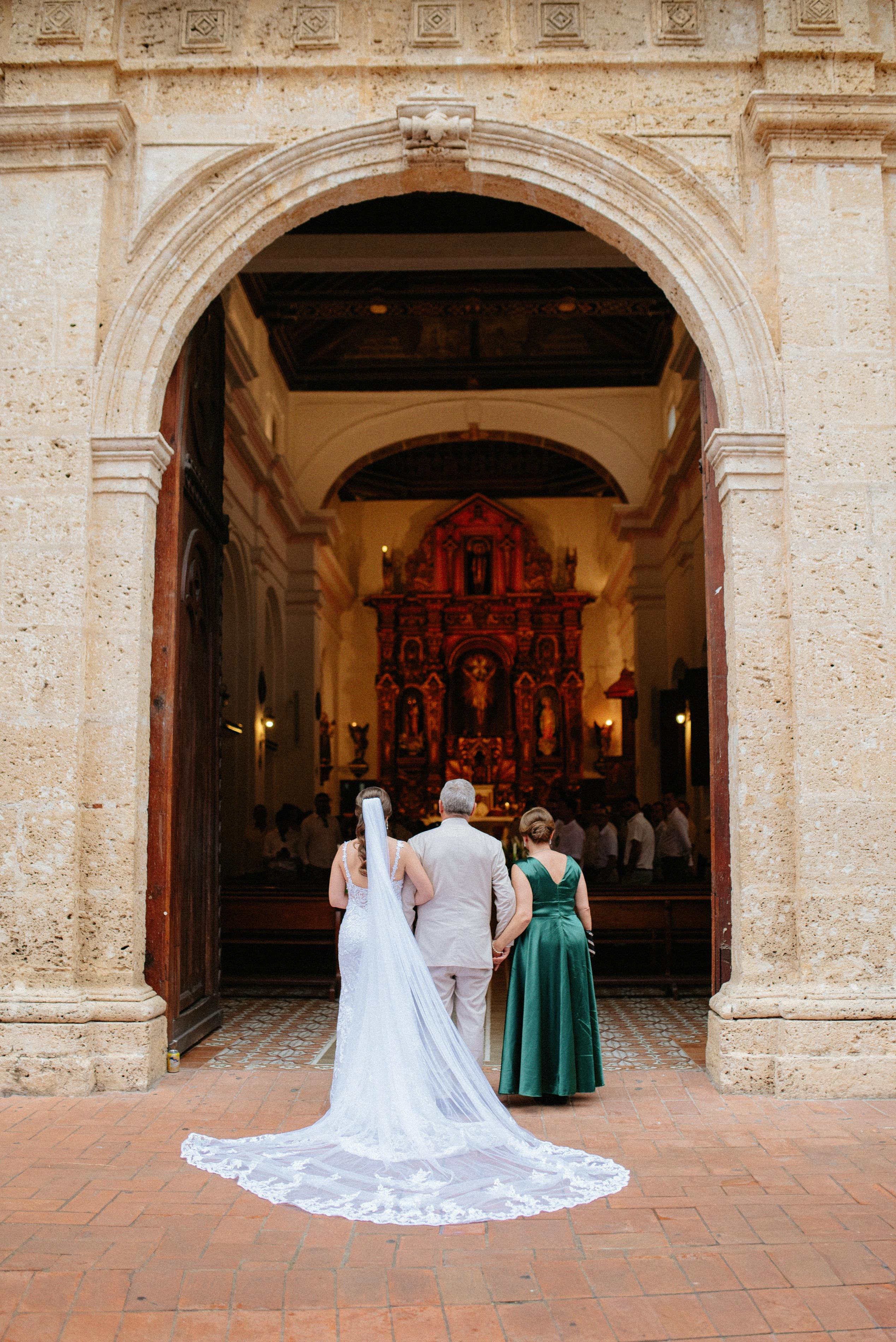 Bride and groom entering a historic church in Cartagena, romantic destination wedding photography