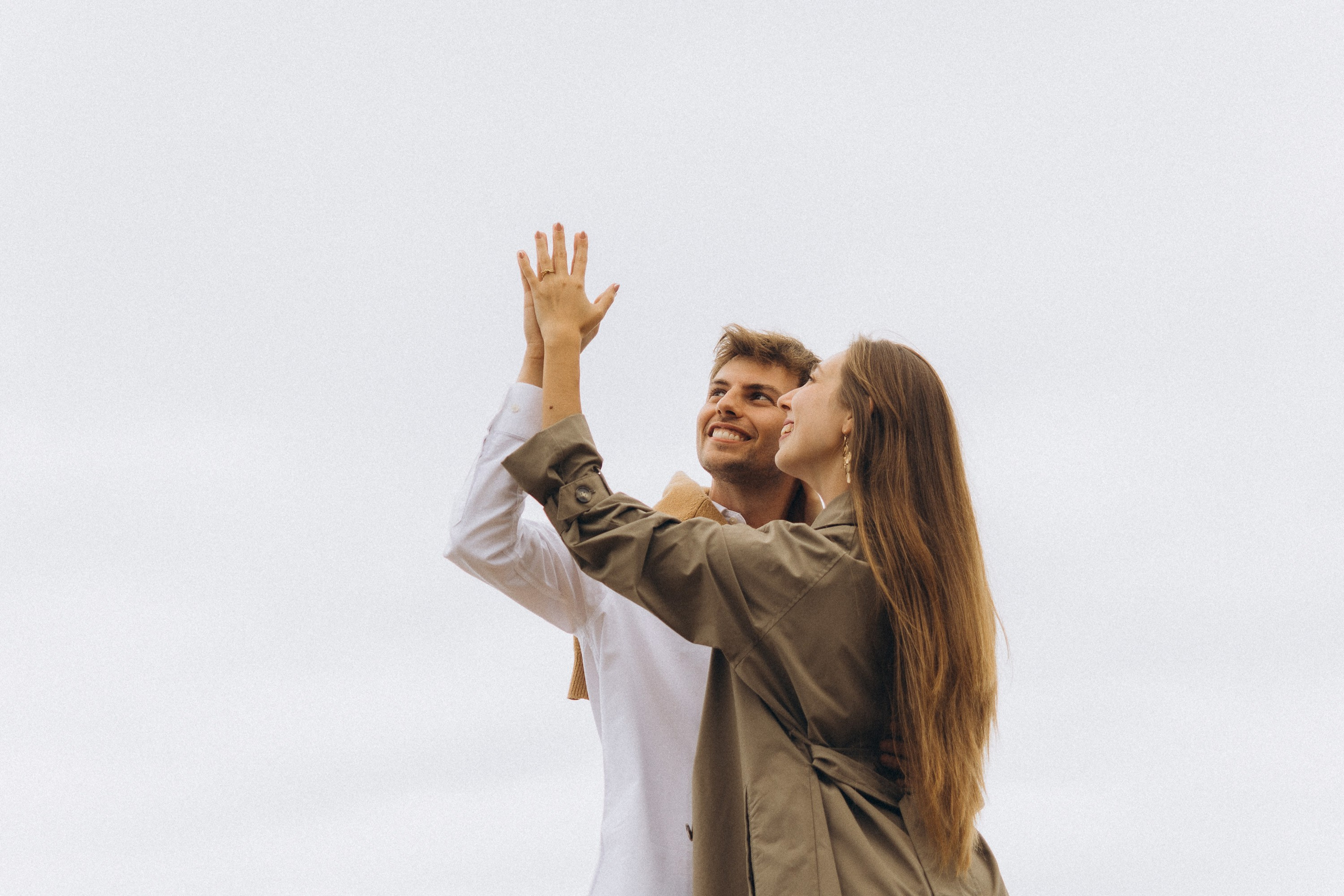 Romantic surprise proposal at sunset on a scenic cliffside in Madeira, Portugal, capturing the emotional moment of love and commitment.