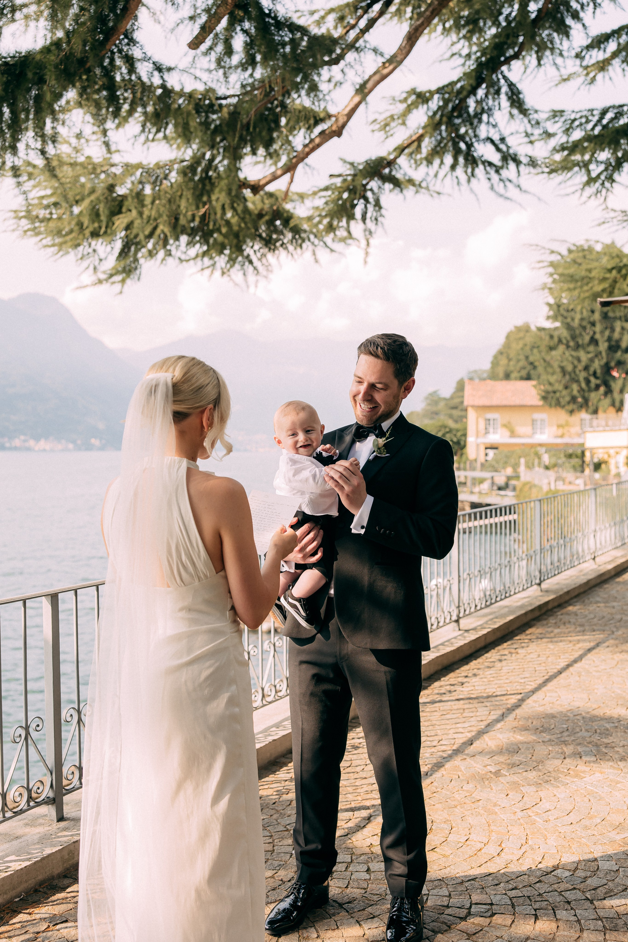 Bride and groom with their baby at Villa Lario, Lake Como, Italy