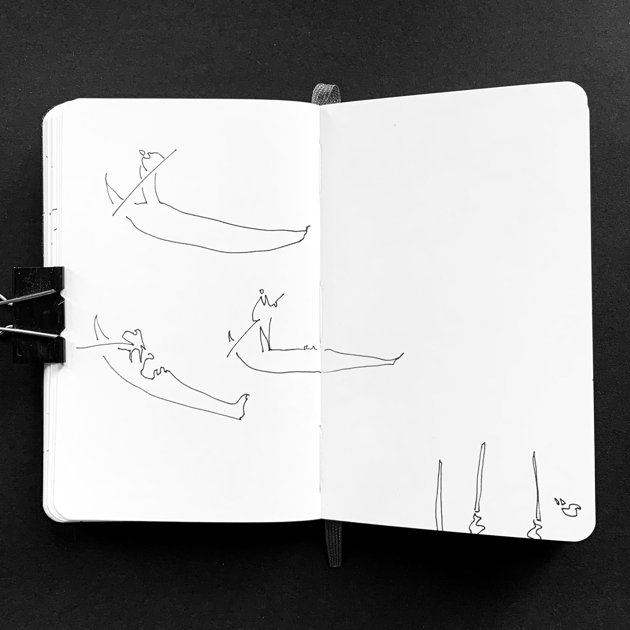 Moleskine notebook with hand-drawn sketches made in Venice, showcasing Nadia Kuprina’s exploration of drawing and the tactile experience of a personal sketchbook. Minimalistic drawing of gondolas.