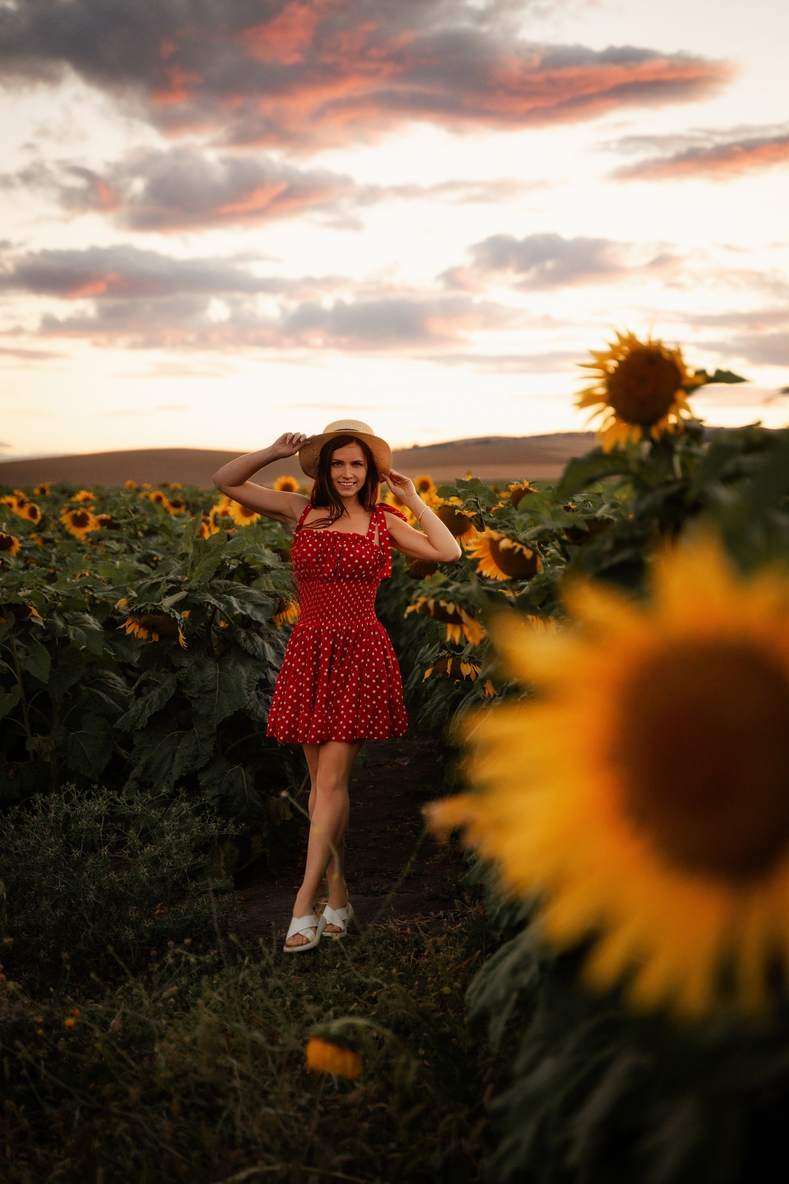 Beautiful woman posing in sunflower field at sunset, photographed by Marbella portrait photographer
