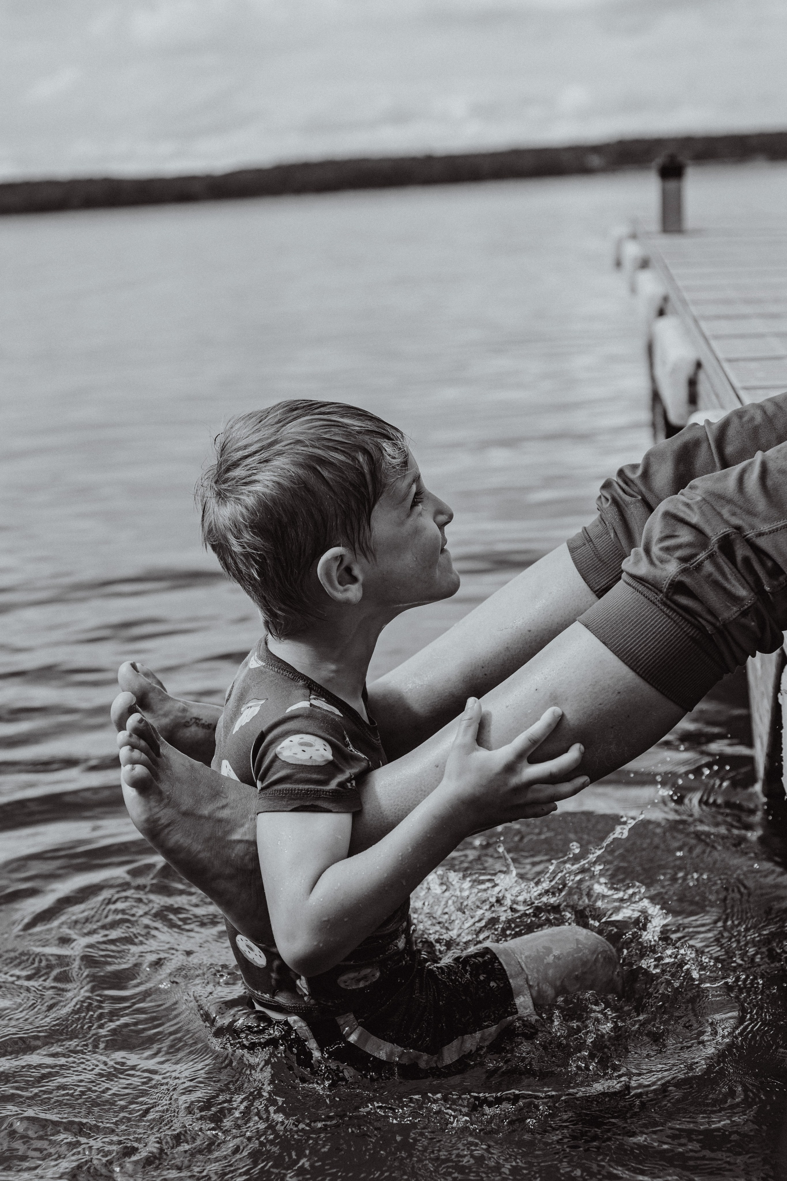 Family and pet-friendly photographer in De Pere, Wisconsin, capturing joyful moments with families and their dogs in a relaxed, outdoor setting.