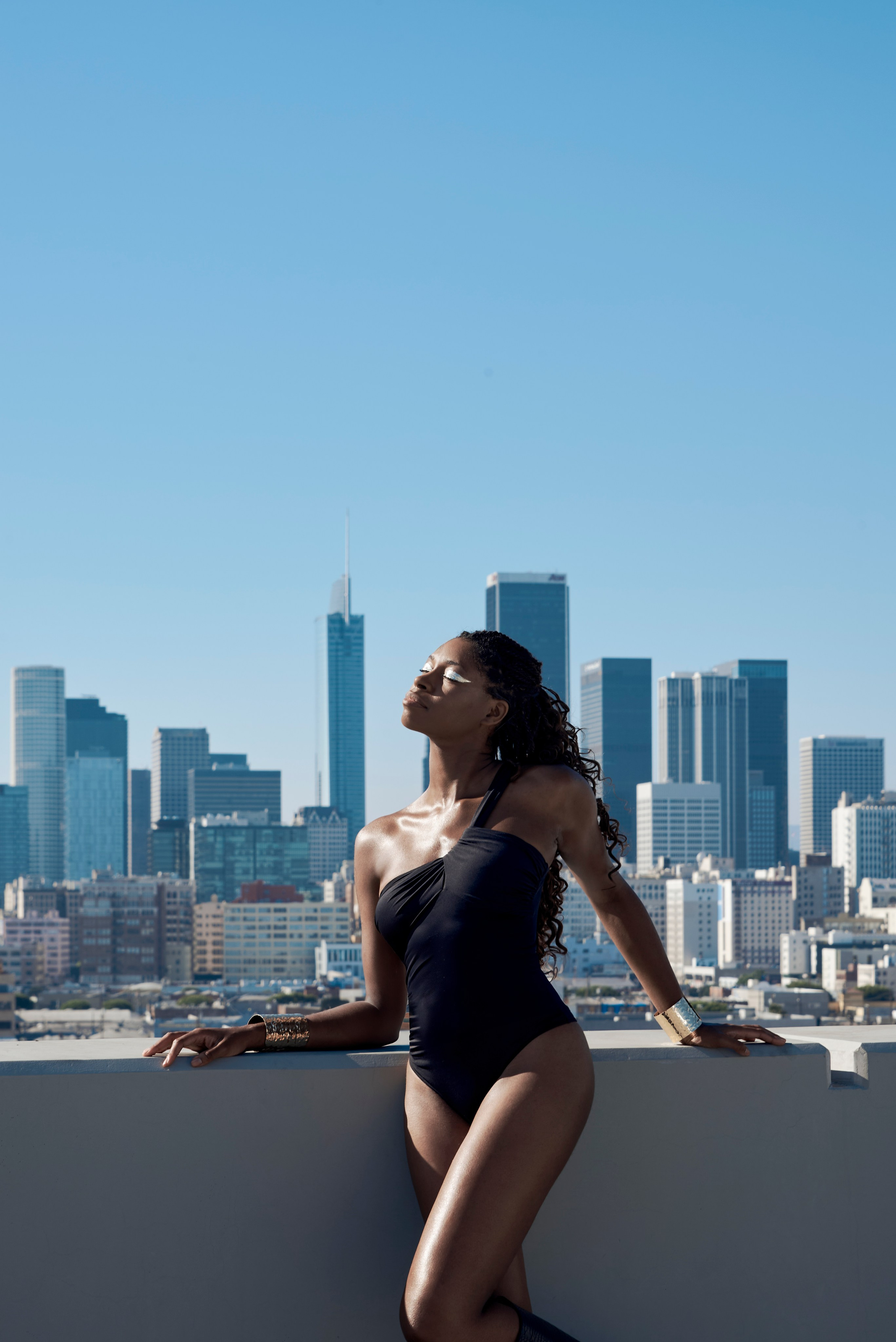 Elegant portrait of a woman in black with Los Angeles in the background