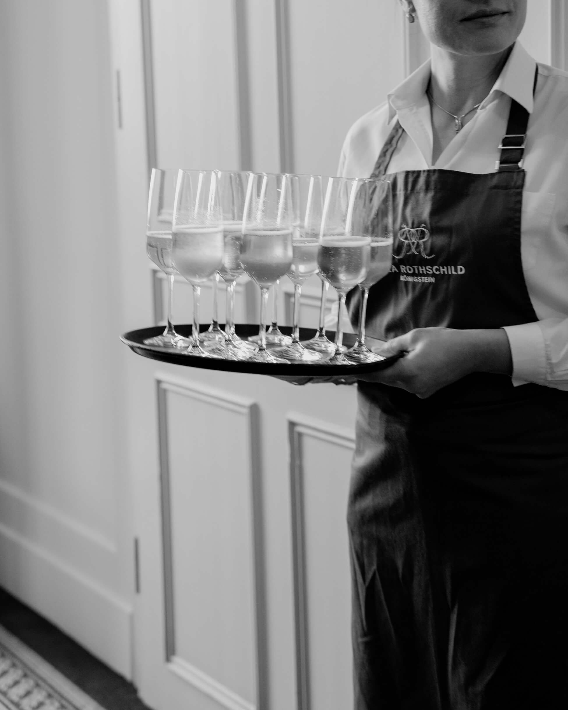 Waiter carrying champagne tray at luxury wedding cocktail hour, Villa Rothschild Frankfurt